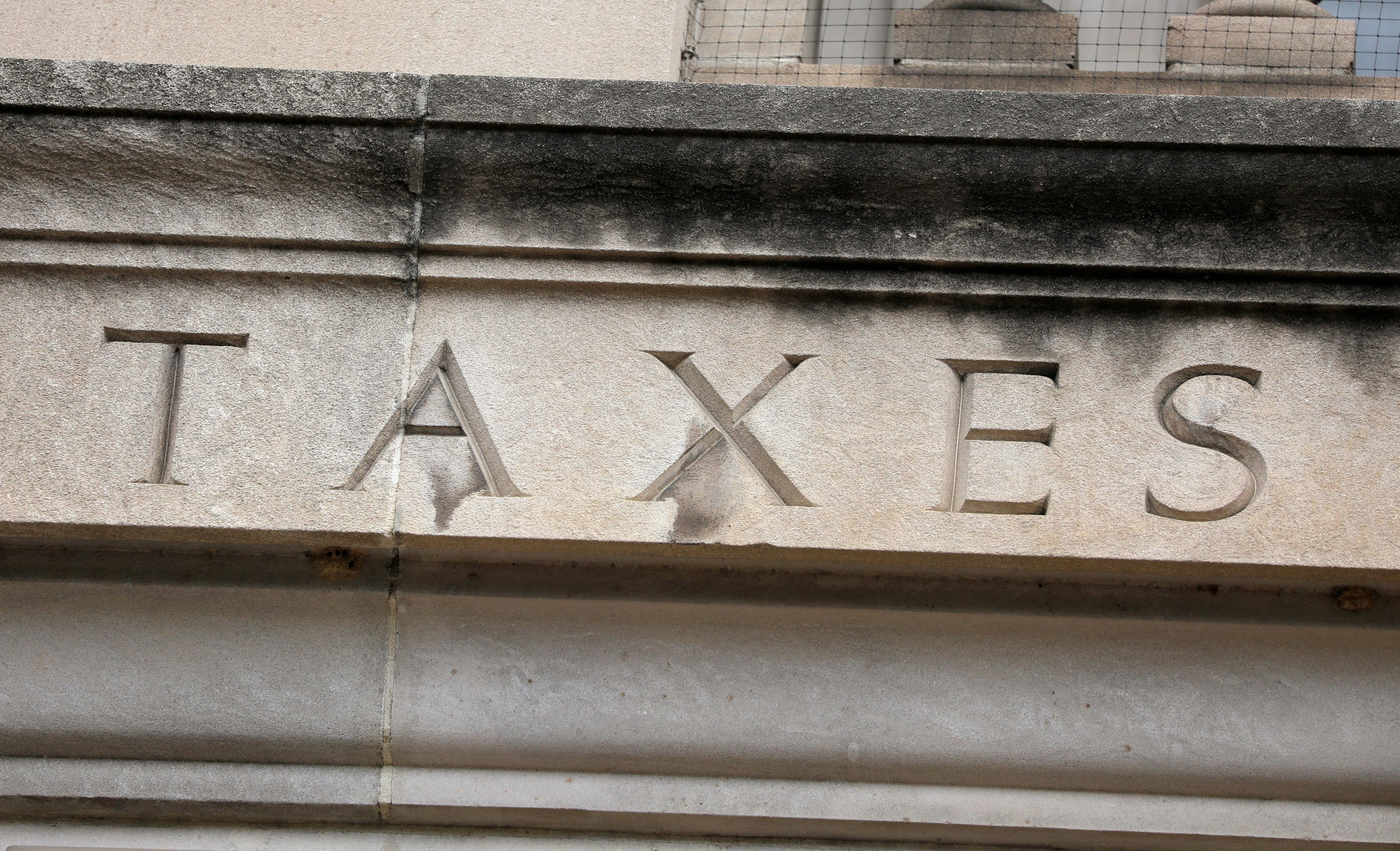 The word "taxes" is seen engraved at the headquarters of the Internal Revenue Service (IRS) in Washington, D.C., U.S., May 10, 2021. 