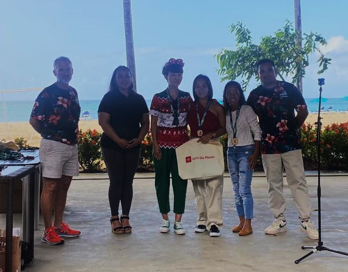 Rosemarie Chisato, Ann Bang, and Jessica Ortizo pose for a photo with Run Saipan President Edward Dela Cruz Jr and Treasurer Dr. Ron Snyder during the awards ceremony of the 2023 Run Saipan Holiday Half Marathon & AK 5K Fun Run at Crowne Plaza Resort. 