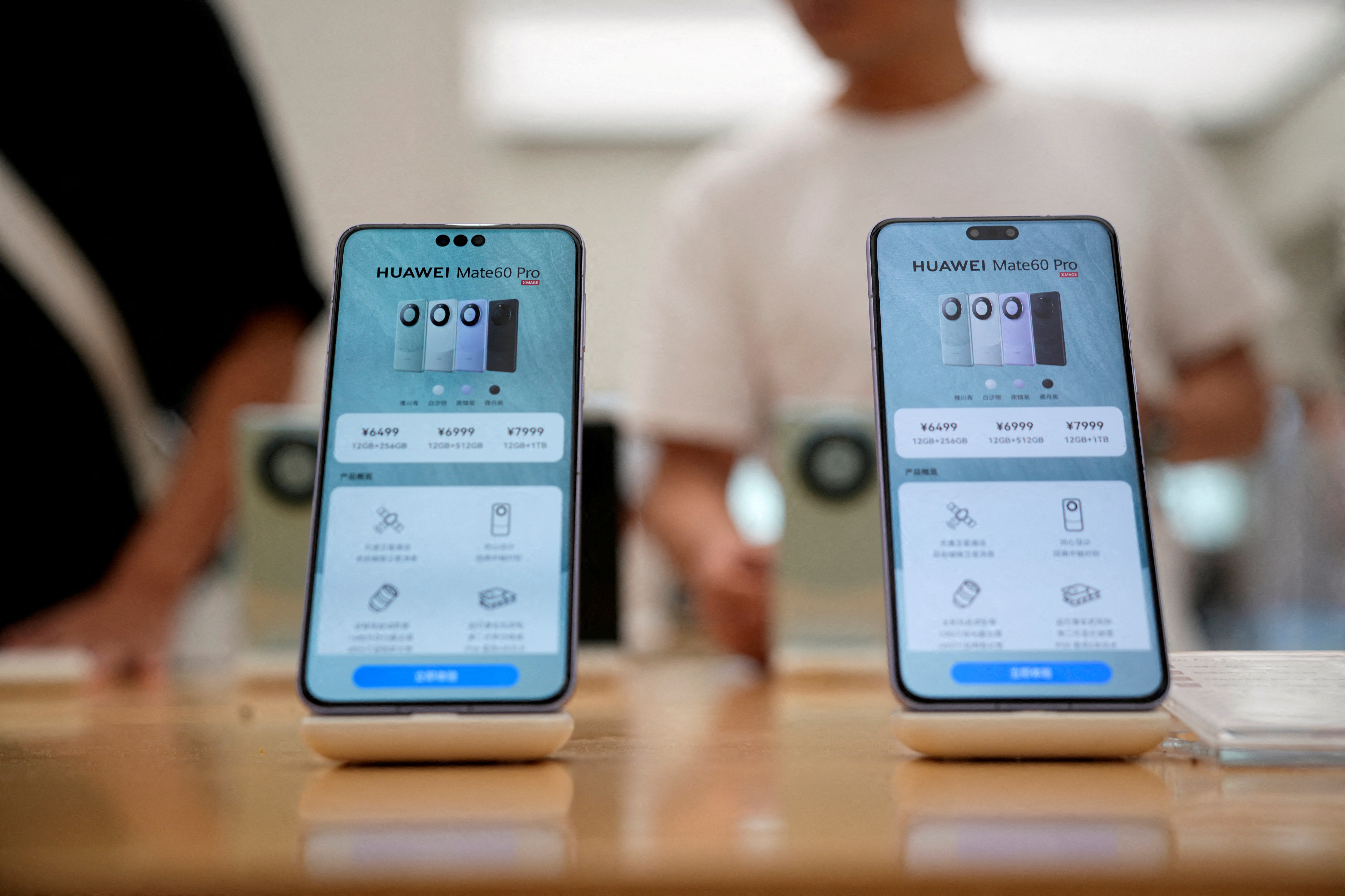Pricing details of Huawei's Mate 60 Pro smartphones are seen on smartphones displayed at a Huawei store in Shanghai, China September 8, 2023. 