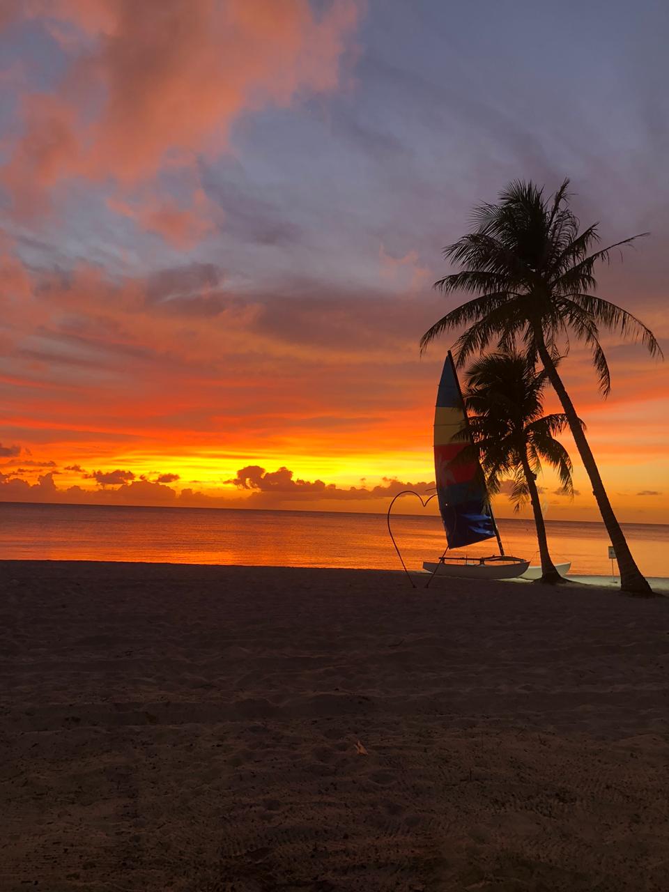 Experience a stunning sunset at Surf Club Restaurant, complete with their iconic heart symbol.