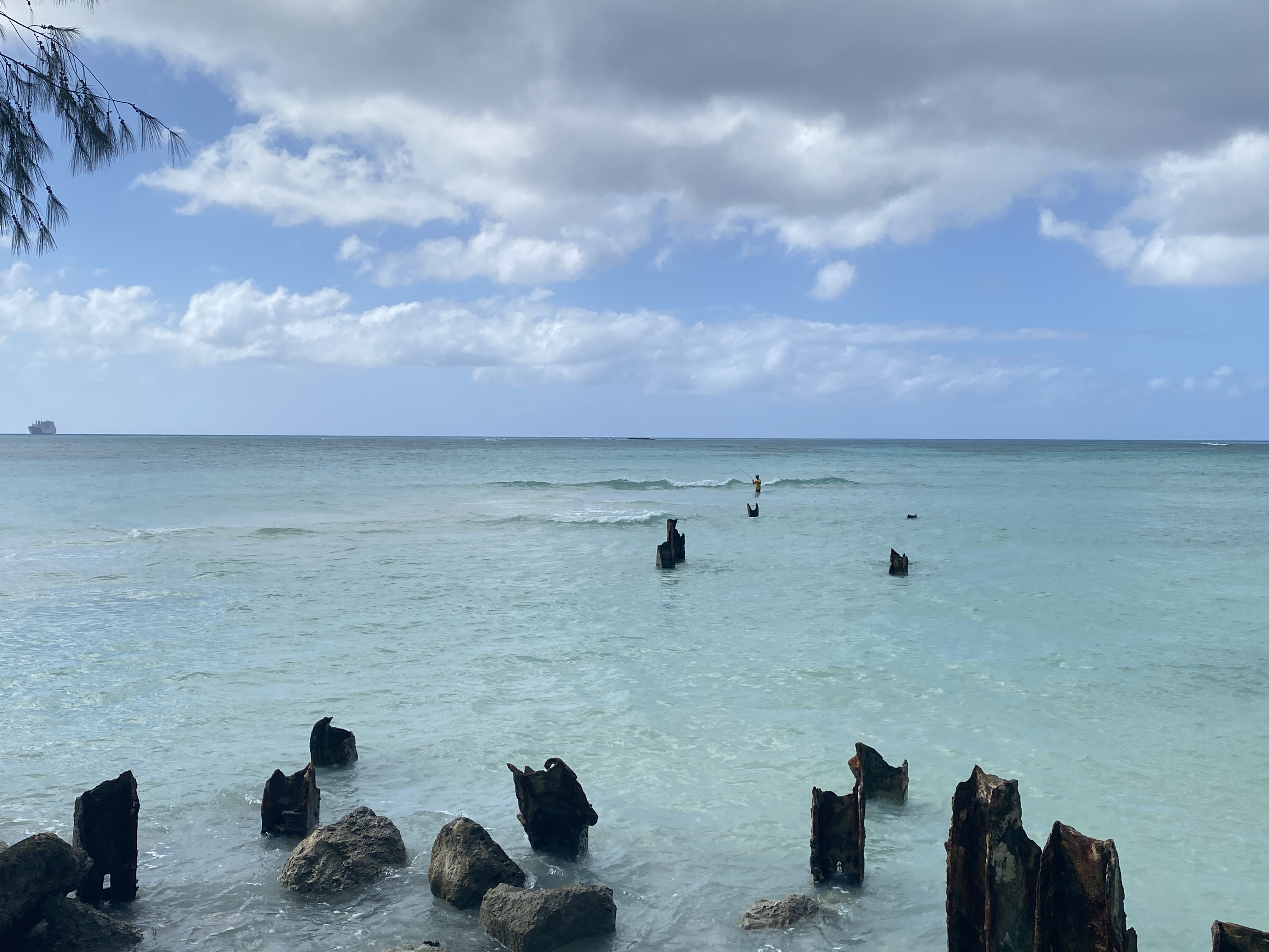 A fisherman stands at a Micro beach sandbar on Tuesday, Dec. 26, 2023.