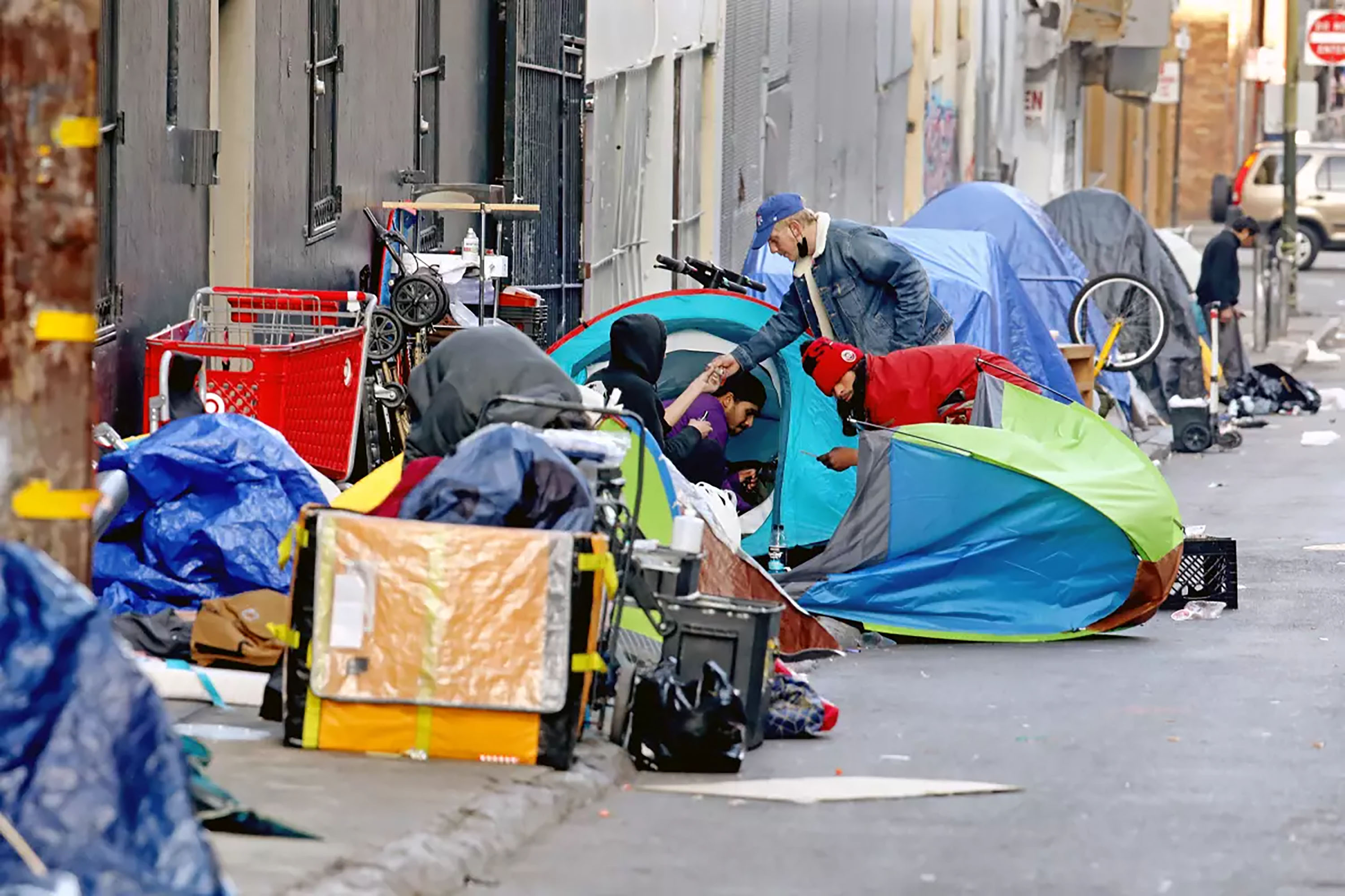 Homeless people consume illegal drugs in an encampment in the Tenderloin district on Feb. 24, 2022, in San Francisco. (Gary Coronado/Los Angeles Times/TNS)