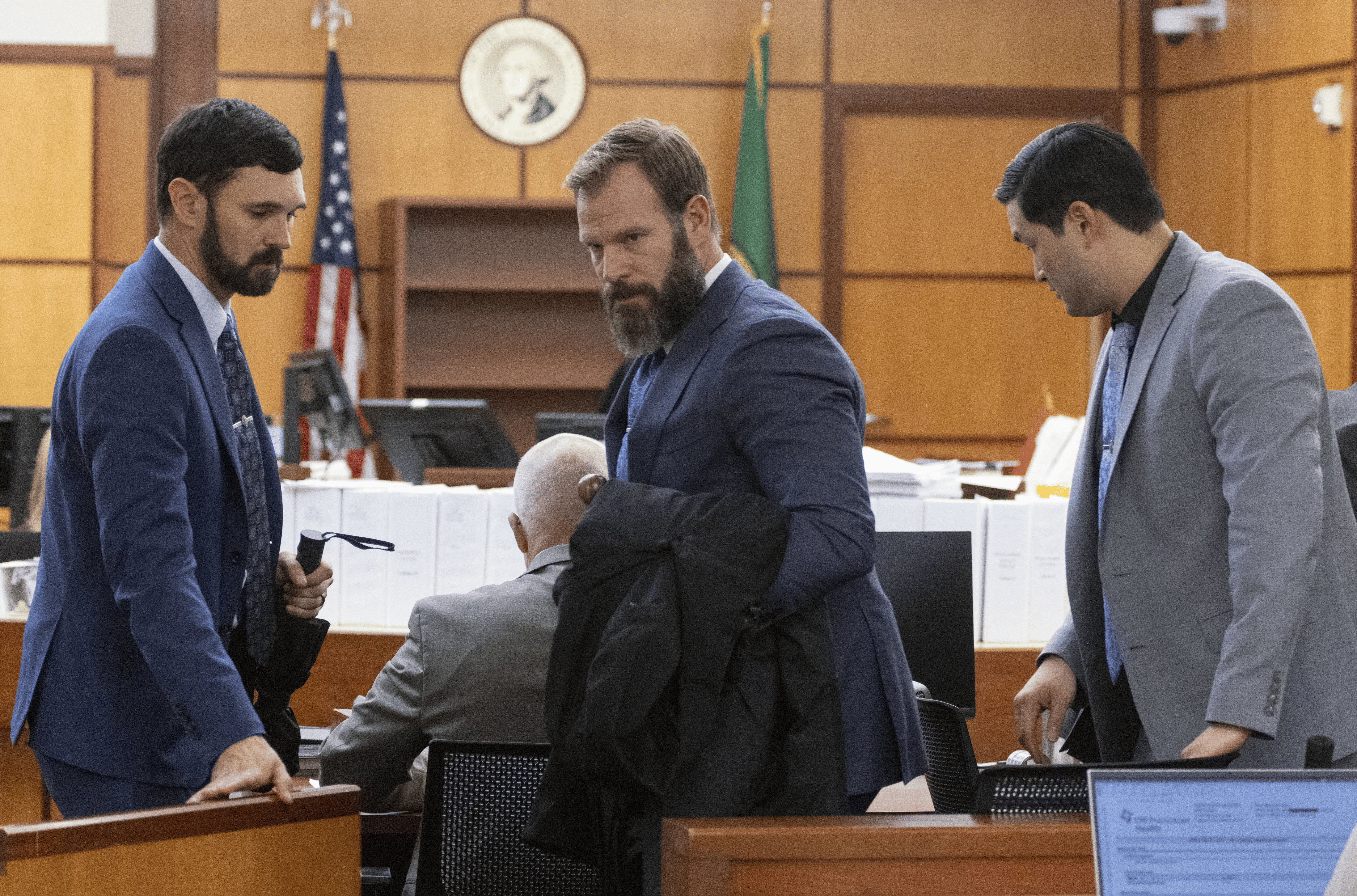 After the prosecution and defense rested their cases three Tacoma police officers, Christopher Burbank, Matthew Collins and Timothy Rankine, on trial in the killing of Manny Ellis, get up and head out of Pierce County Superior Court in Tacoma, Washington, U.S., December 6, 2023. 