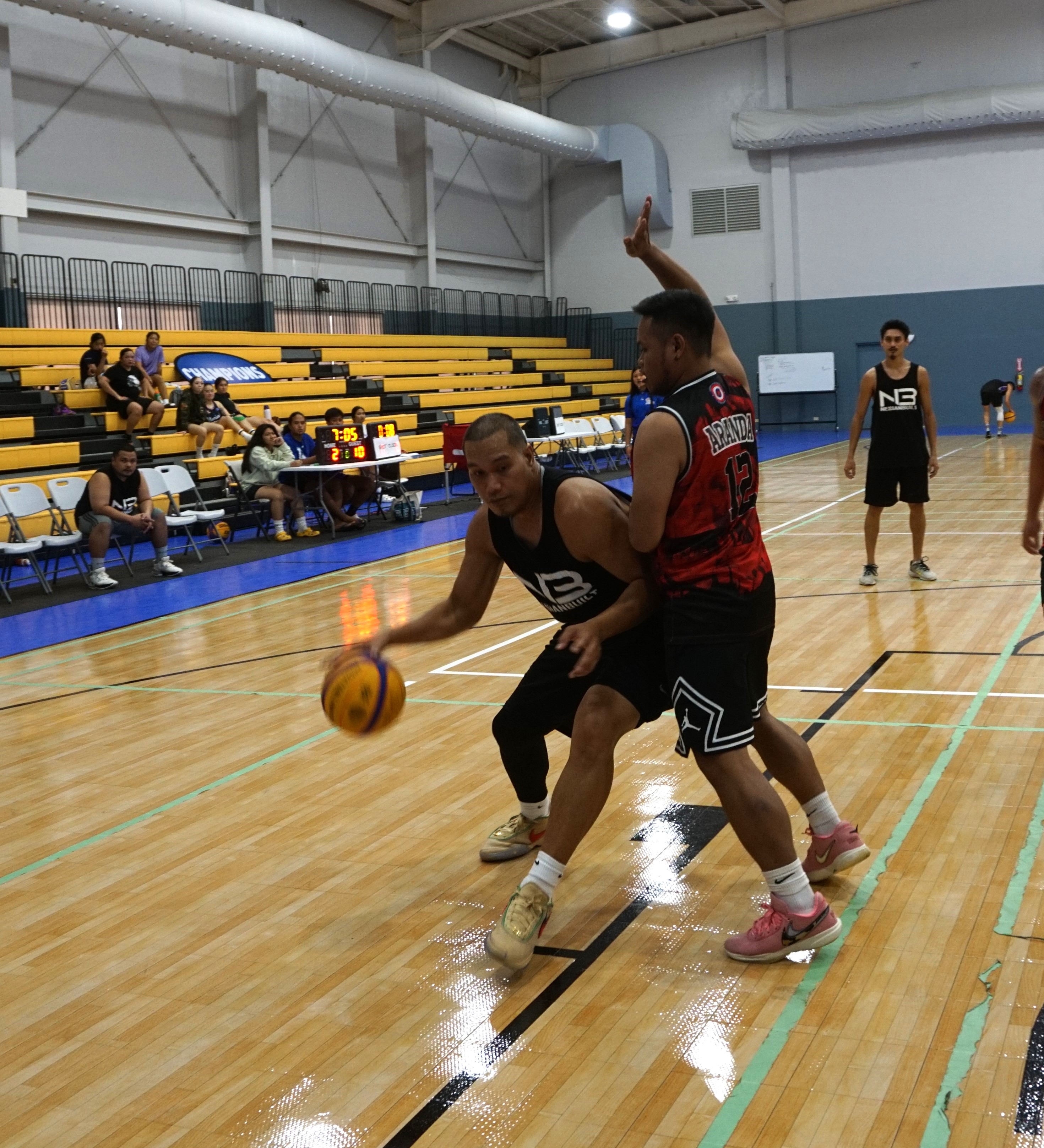 Team Nesian Built’s Jack Lizama posts against the Net Ripper's Jack Aranda during the men’s division championship game of the Marianas Arsenal 3x3 Series at the Ada gym on Saturday.
