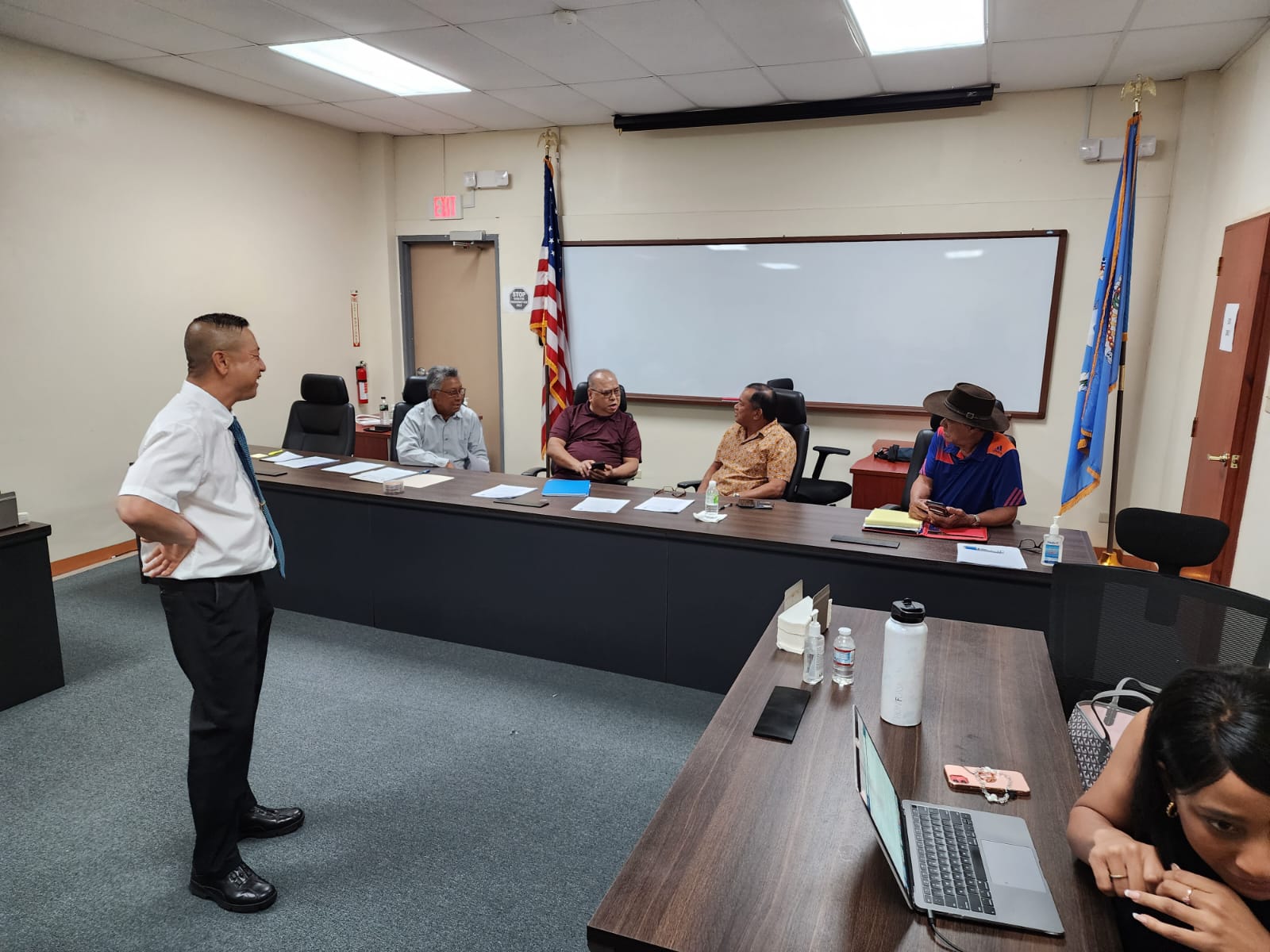 Commonwealth Casino Commission Executive Director Andrew Yeom, left, standing, smiles as Commissioner Mario Taitano, Chairman Edward C. Deleon Guerrero, Vice Chairman Ralph S. Demapan and Commissioner Ramon M. Dela Cruz confer during a meeting on Thursday.