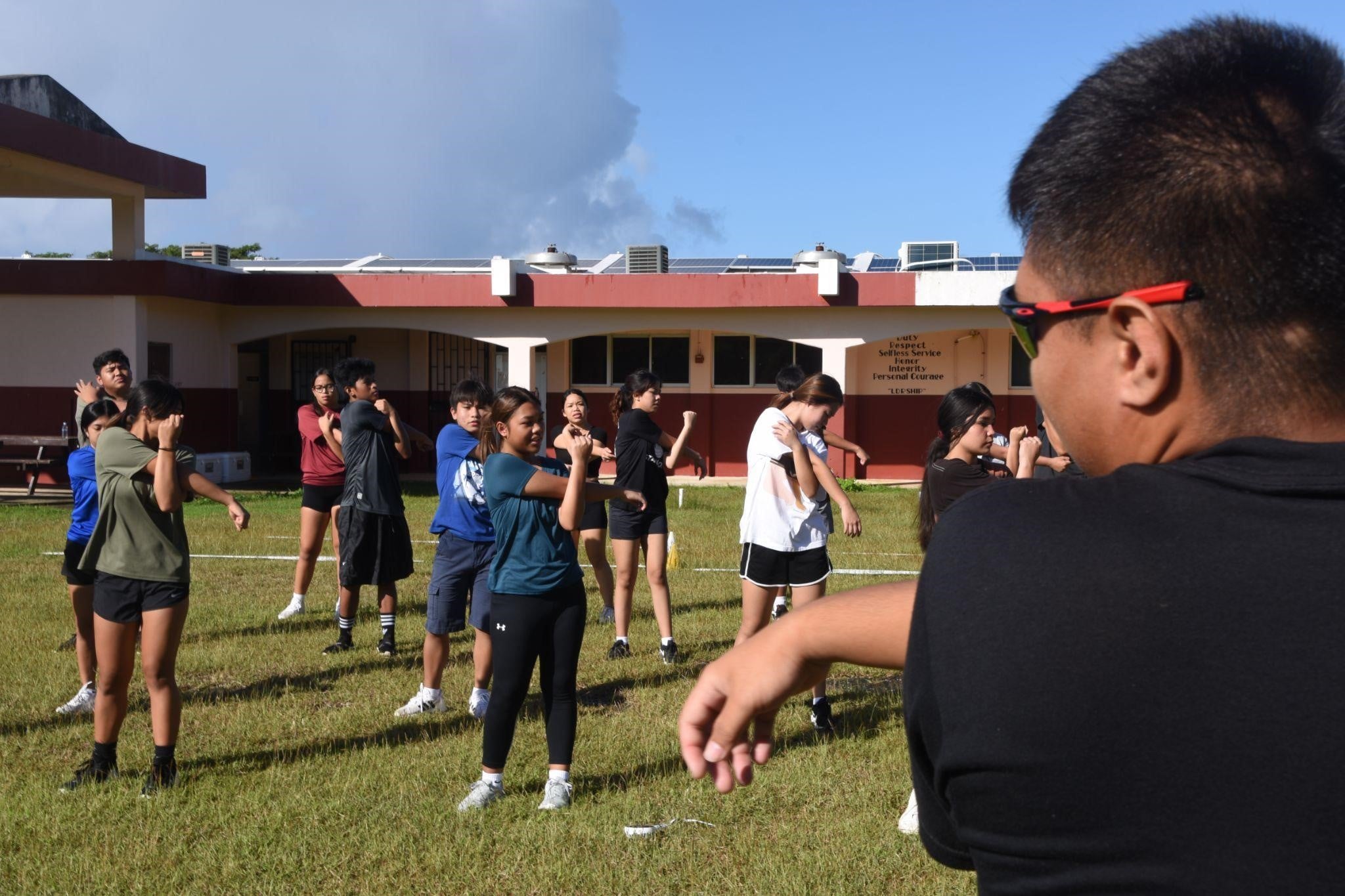 Battalion Commander C/LTC Edward Tirona leads his cadets in stretching exercises.