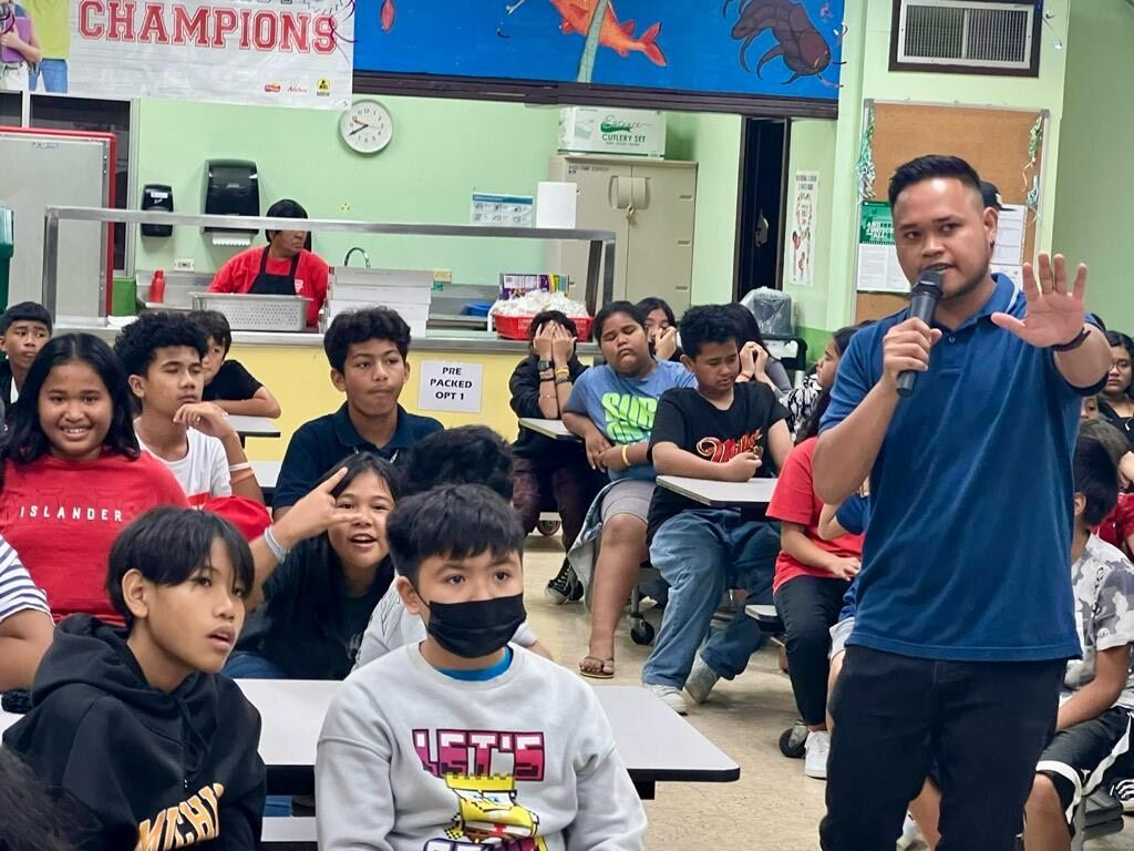 Marianas Visitors Authority Community Projects Specialist Jack Aranda talks about tourism with students of Tanapag Middle School during the educational outreach presentation of MTEC and the Marianas Visitors Authority on Dec. 11, 2023, at the school.