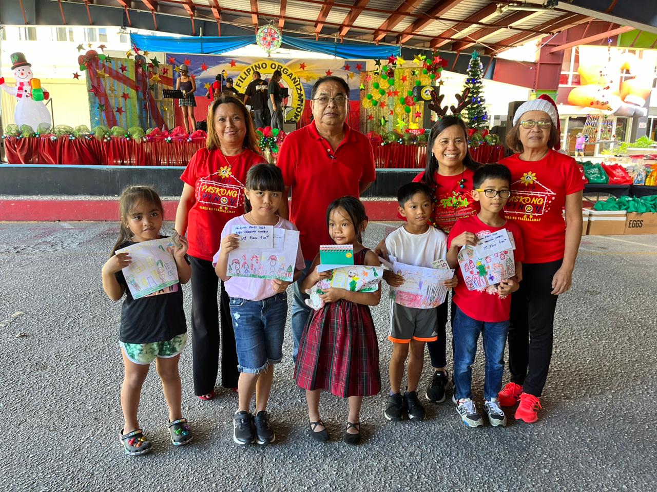 The drawing-contest winners with United Filipino Organization officers.