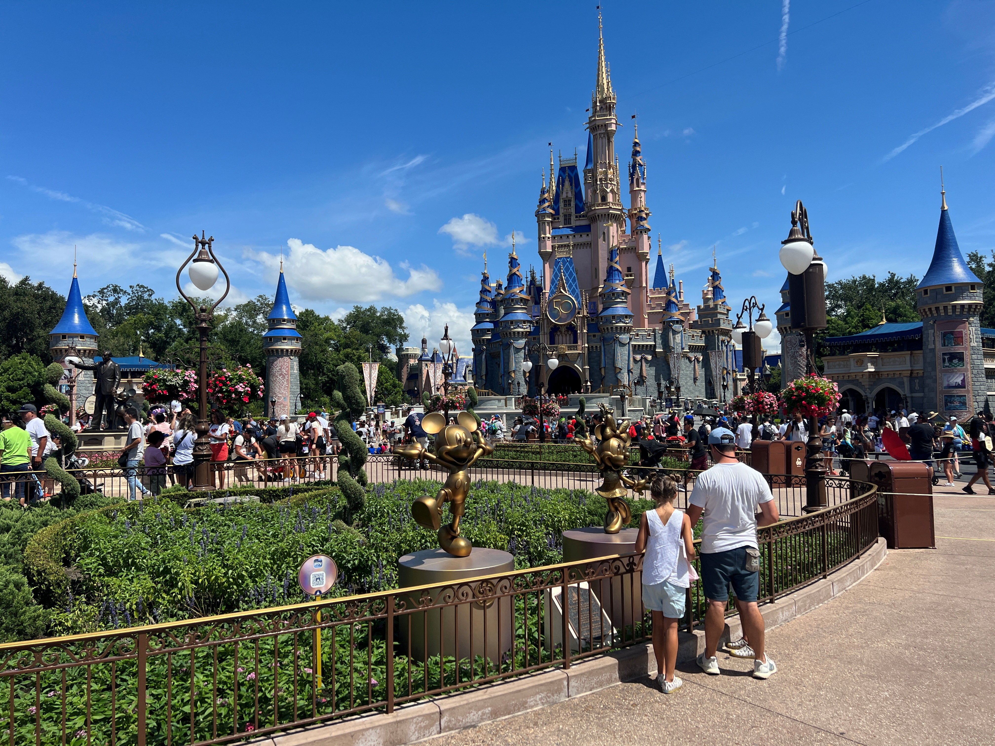 People gather ahead of the "Festival of Fantasy" parade at the Walt Disney World Magic Kingdom theme park in Orlando, Florida, U.S. July 30, 2022. 