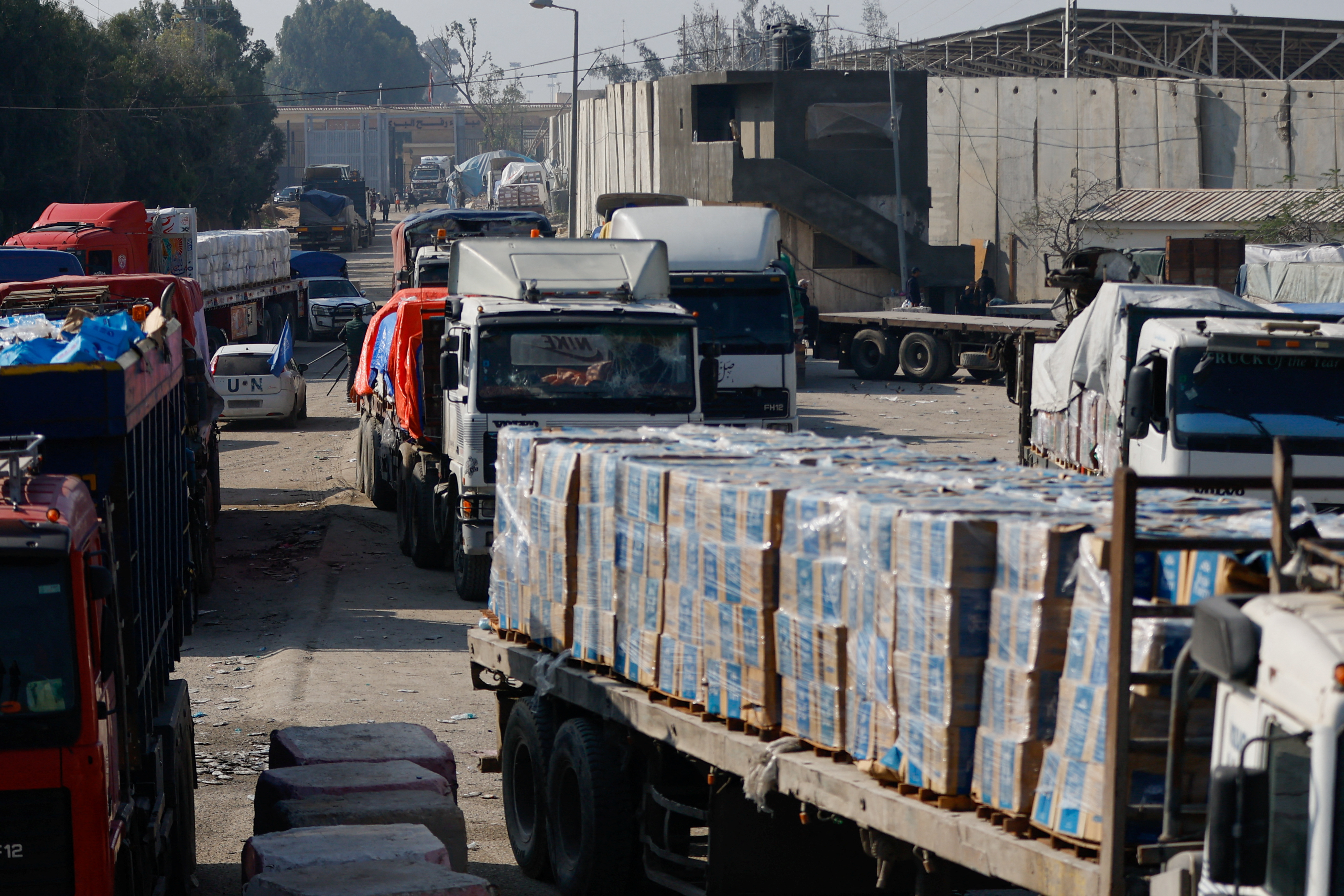 Trucks carrying aid move at Rafah border, amid the ongoing conflict between Israel and the Palestinian Islamist group Hamas, in Rafah in the southern Gaza Strip, December 18, 2023. 