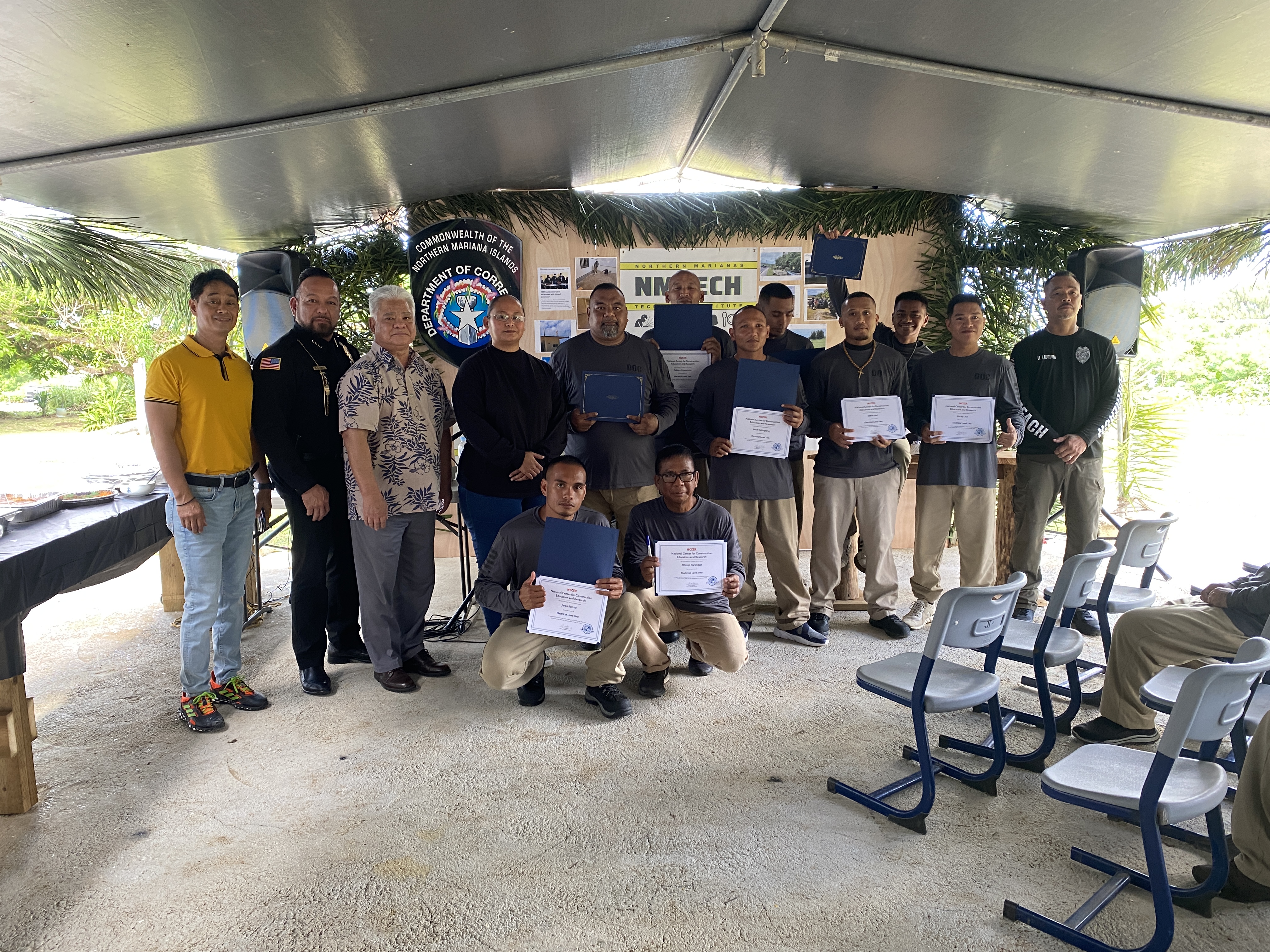 Some of the NMTech graduates of the Department of Corrections outreach program pose with their certificates with, from left, instructor Wendel Posadas, Corrections Commissioner Anthony Torres, Gov. Arnold Palacios, Northern Marianas Technical Institute Chief Executive Officer Jodina Attao, and Lt. Jeff Quitugua, far right.