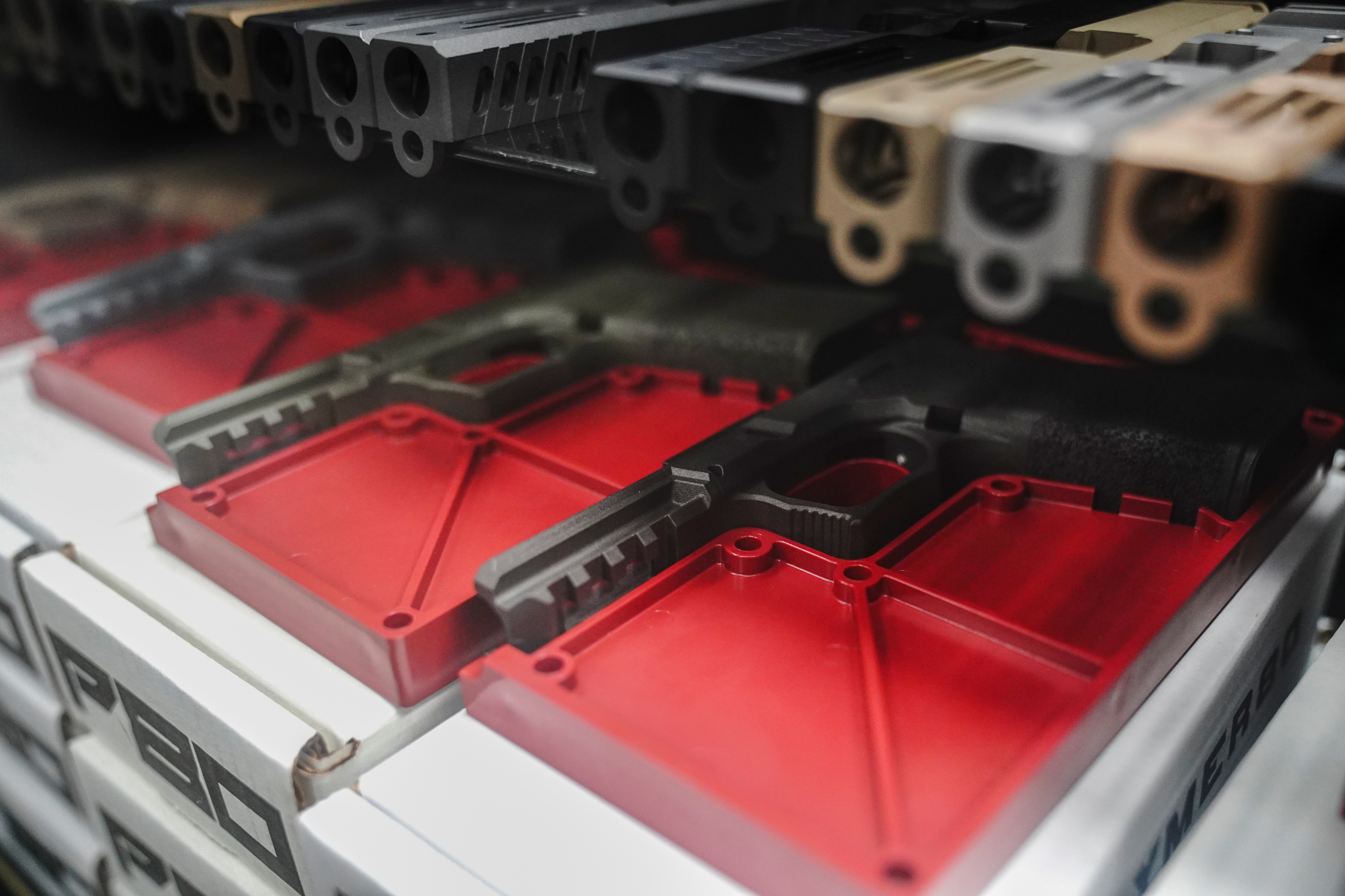 Polymer80 frame kits and upper receivers for Glock semi-automatic pistols are displayed for sale at Firearms Unknown, a gun store in Oceanside, California, U.S., April 12, 2021. Unfinished and inoperable so-called "80% receivers" are not legally considered firearms and do not require background checks to purchase in most states, but can be used to assemble un-serialized "ghost guns". 