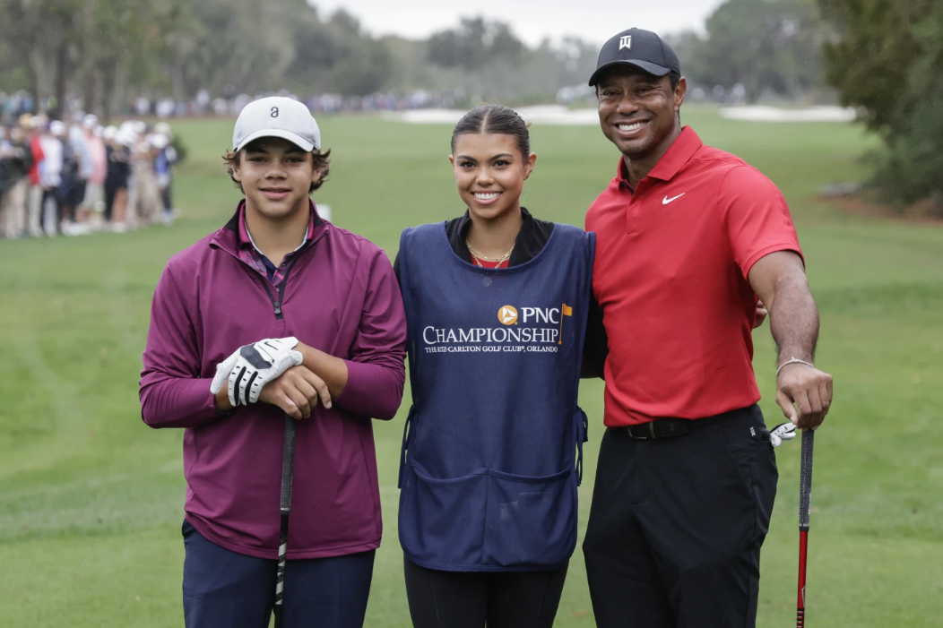 Charlie Woods, left, sister Sam, center, and father Tiger, right stand together at 1st tee during the final round of the PNC Championship golf tournament Sunday, Dec. 17, 2023, in Orlando, Fla.