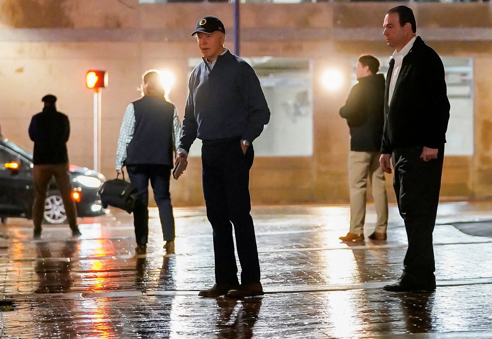 U.S. President Joe Biden reacts after a vehicle crashed into a Secret Service SUV that was blocking the street as Biden exited his campaign headquarters, in Wilmington, Delaware, U.S. December 17, 2023. 