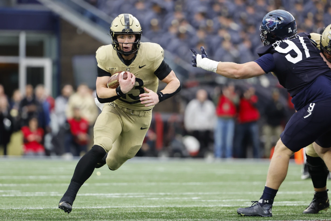 Army quarterback Bryson Daily runs through a hole past Navy defensive tackle Clay Cromwell during the first quarter of an NCAA football game at Gillett Stadium Saturday, Dec. 9, 2023 in Foxborough, Mass.