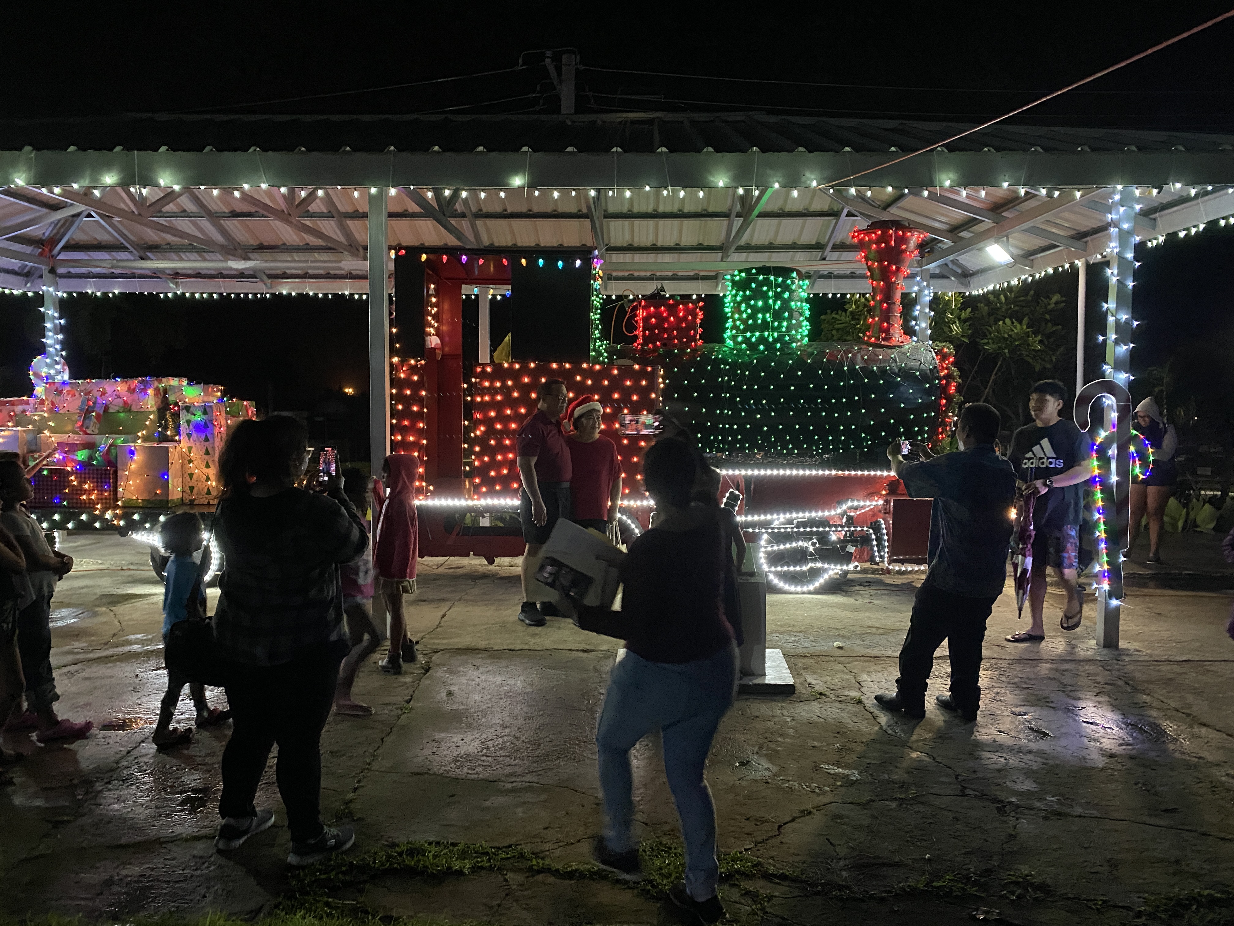 The train engine is lit up for the holidays and ready for visitors.