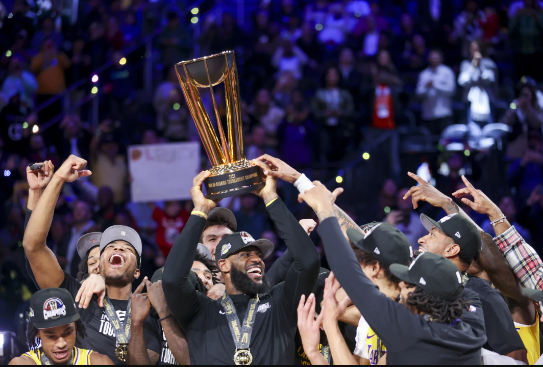 Los Angeles Lakers forward LeBron James, center, lifts the NBA Cup while celebrating with teammates after they defeated the Indiana Pacers 123-109 in the championship game of the NBA In-Season Tournament on Saturday, Dec. 9, 2023 in Las Vegas.