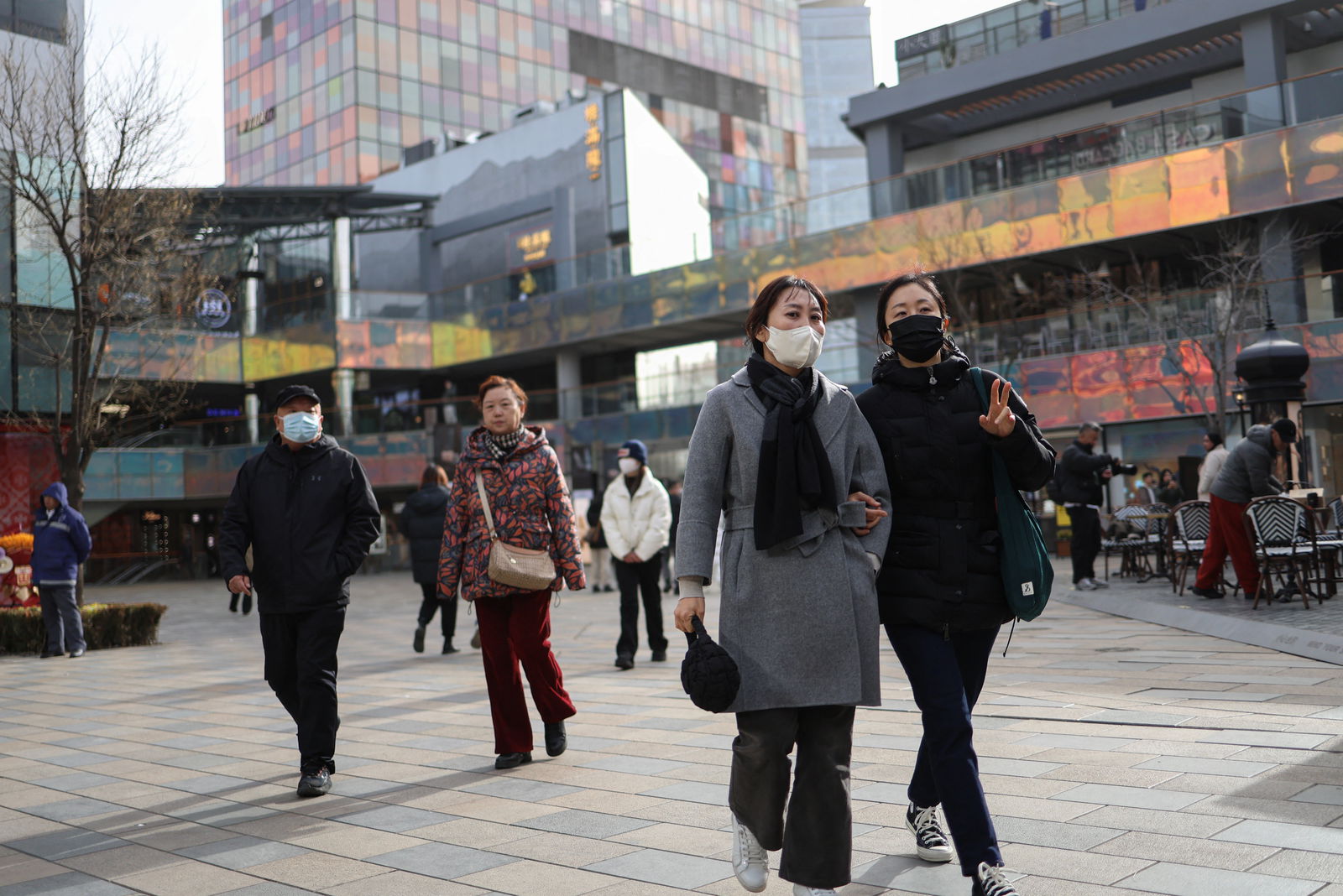 People walk at a shopping compound in Beijing, China, Dec. 6, 2023.
