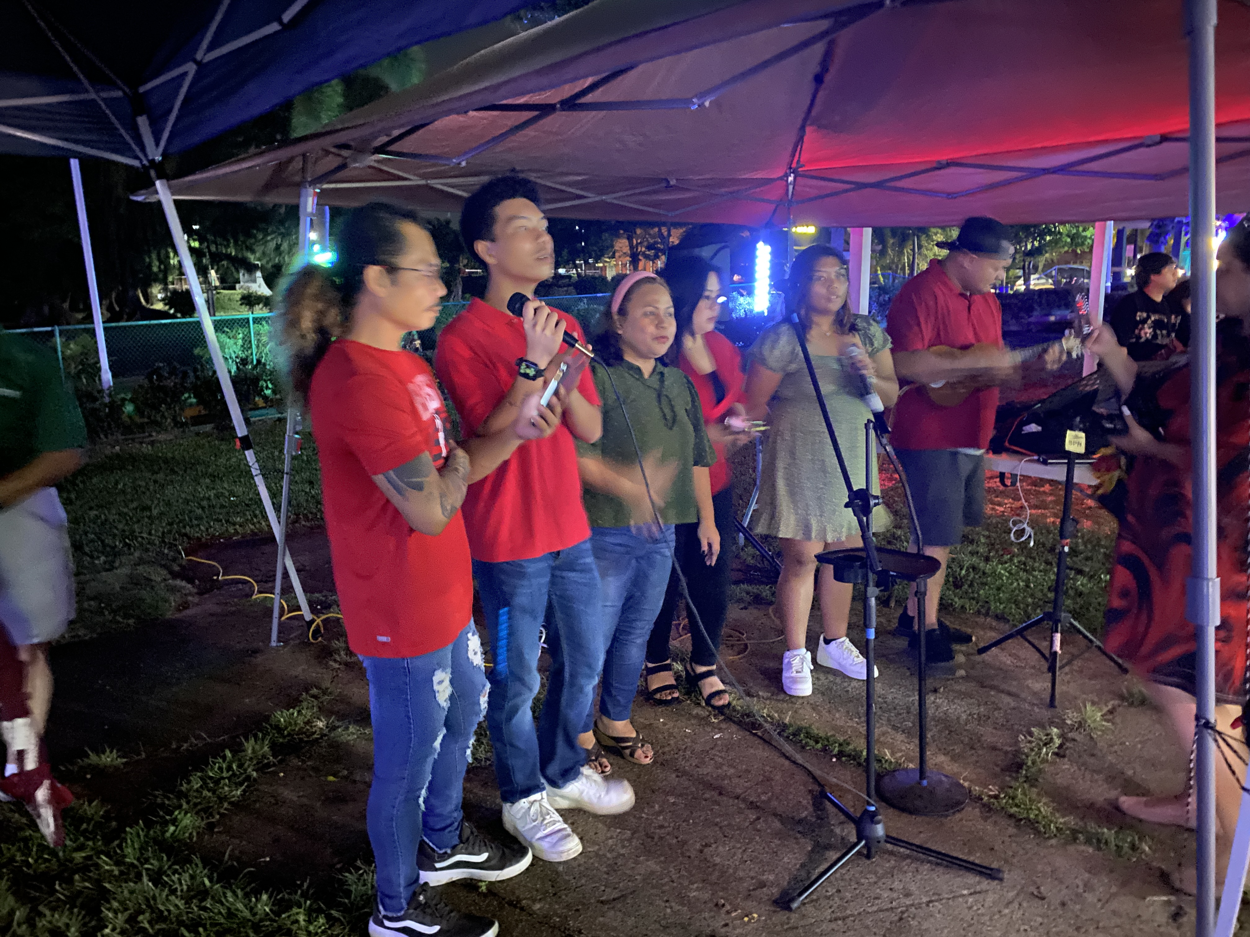 Carolers sing at Sugar King Park during the Christmas in the Park lighting event.
