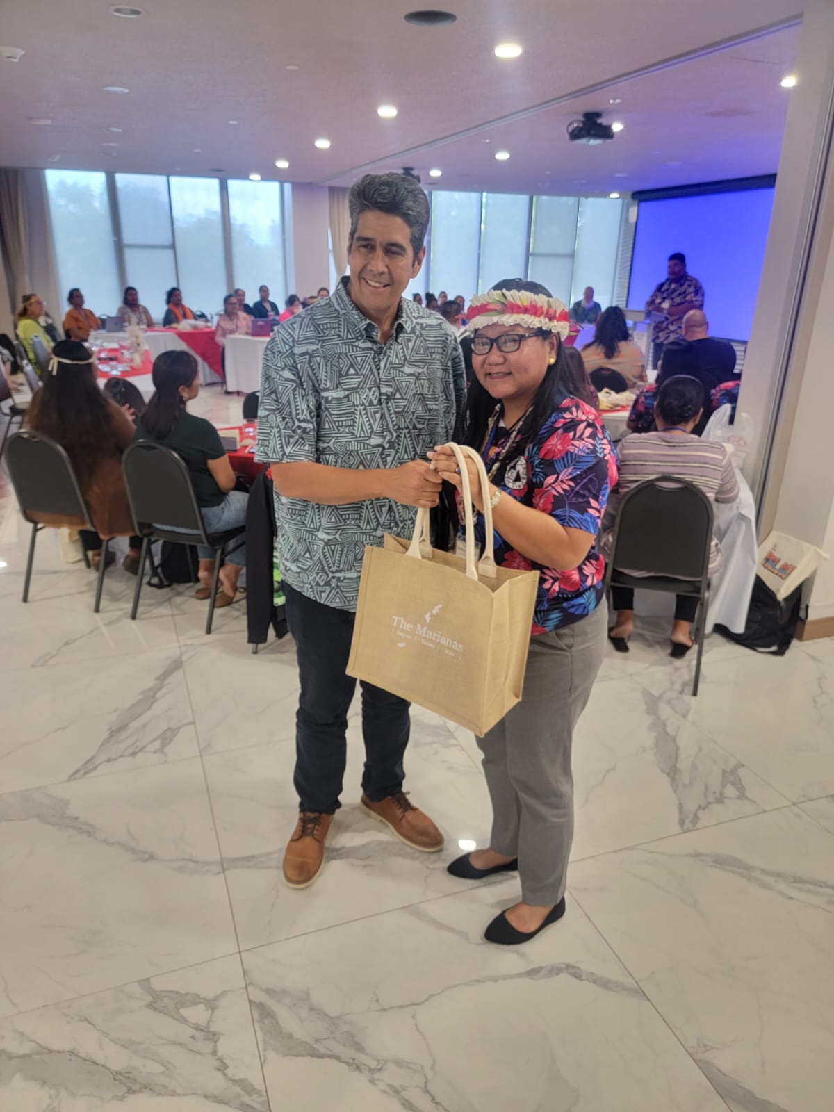Pacific Islands Association of Libraries President Erlinda Naputi of the CNMI presents a gift to Palau President Surangel Whipps Jr. after he delivered a welcoming address  during the PIALA conference in Koror, Palau.