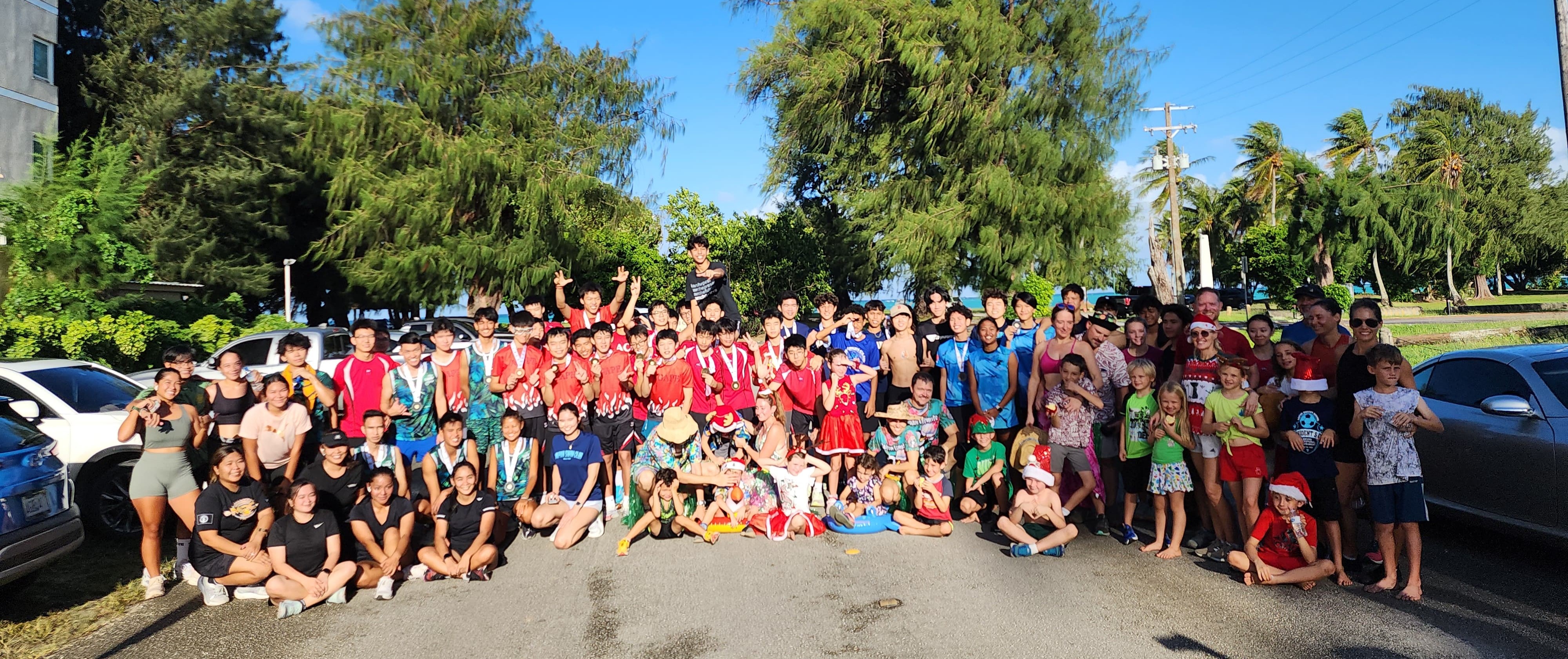 Team participants pose for a group photo after completing the Christmas Island Relay hosted by Northern Marianas Athletics on Saturday at Micro Beach.