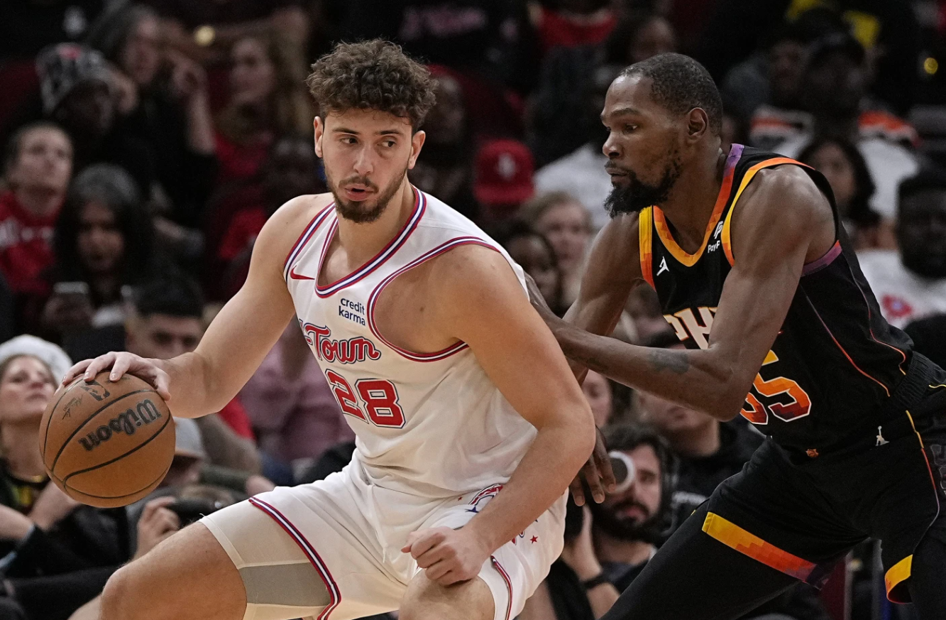Houston Rockets center Alperen Sengun (28) is defended by Phoenix Suns forward Kevin Durant (35) during the second quarter of an NBA game Wednesday, Dec. 27, 2023 in Houston.