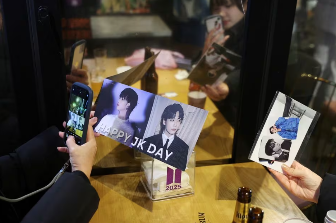 Japanese fans share a moment at a BTS-themed cafe in Seoul, South Korea, Dec. 11, 2023.