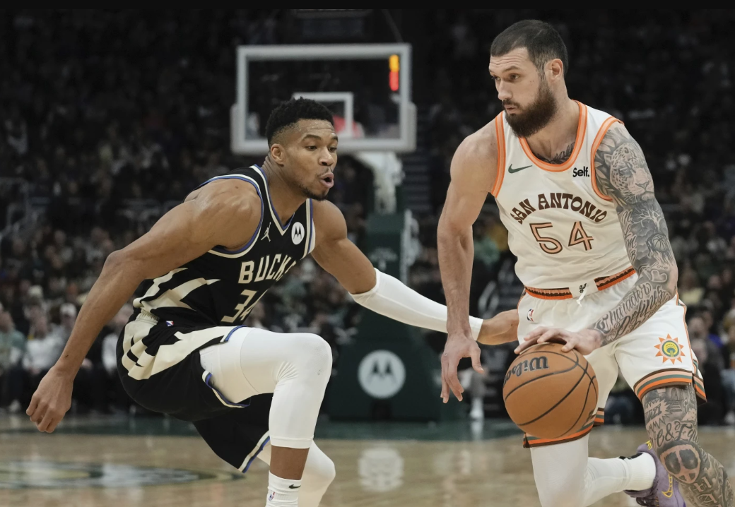 San Antonio Spurs’ Sandro Mamukelashvili tries to get past Milwaukee Bucks’s Giannis Antetokounmpo during the first half of an NBA game Tuesday, Dec. 19, 2023 in Milwaukee.