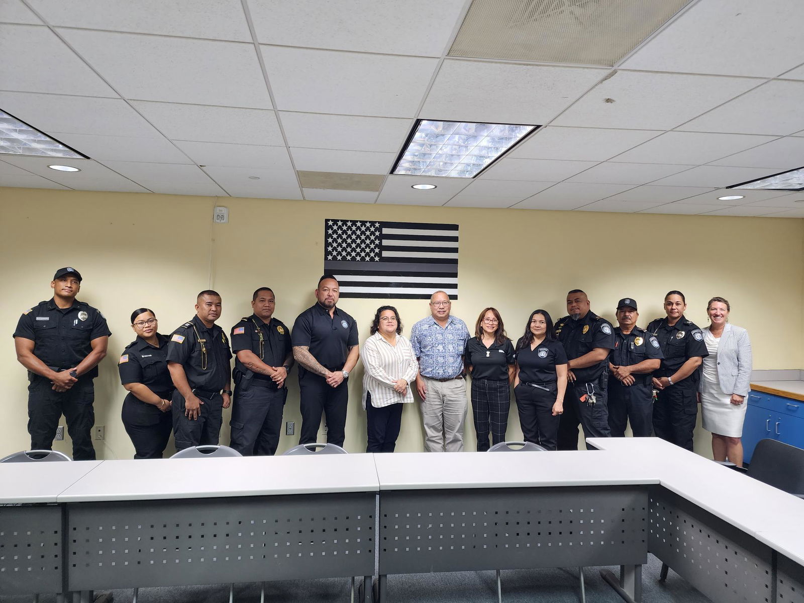 Guam State Clearinghouse Officer Stephanie Flores, center, with Guam Department of Corrections Director Fred Bordallo, Guam Department of Youth Affairs Director Melanie Brennan, CNMI Corrections Commissioner Anthony Torres, and CNMI Corrections officers pose for a photo during a press conference  at the Saipan Corrections facility on Wednesday afternoon.