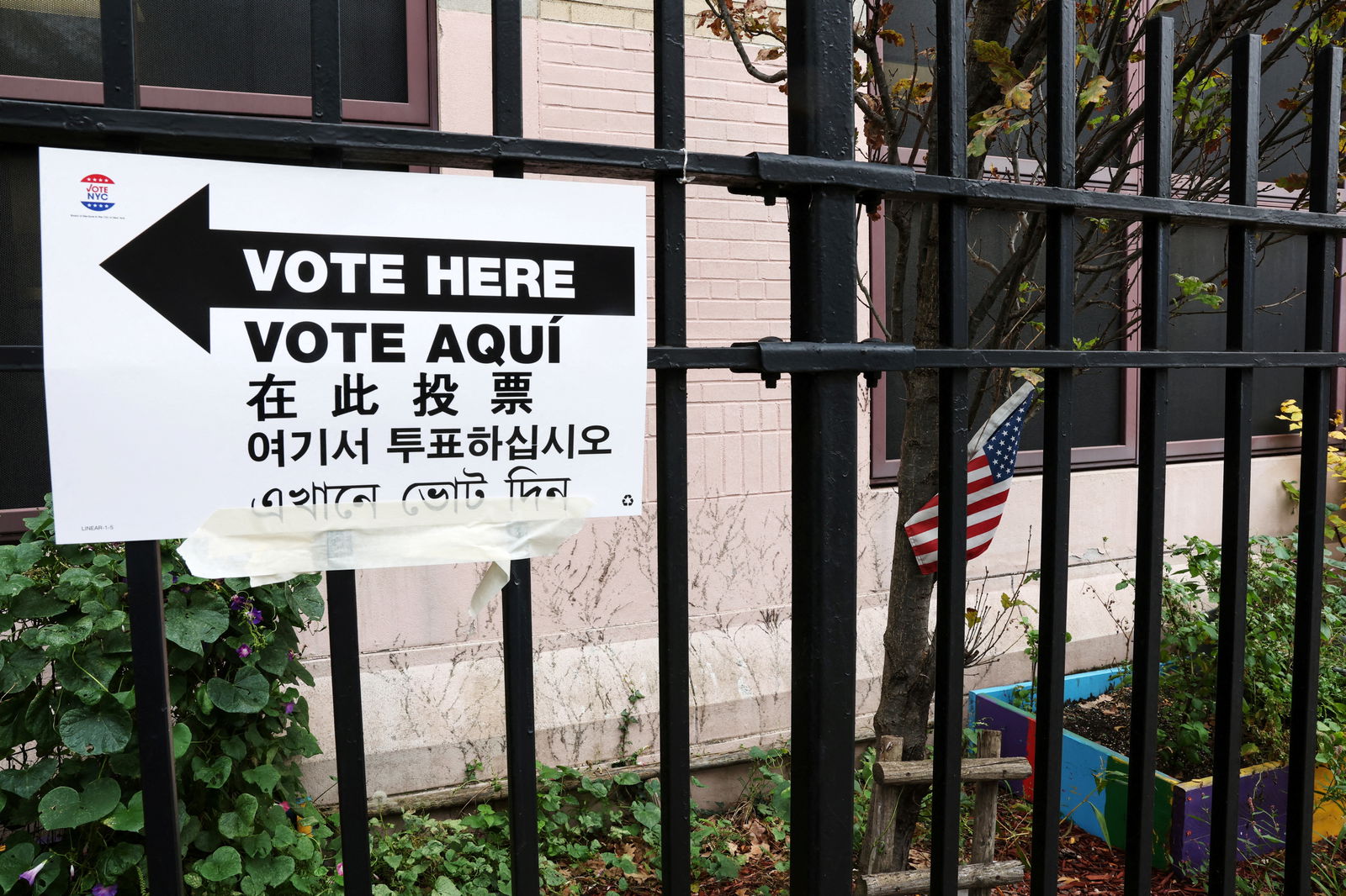 A multi-lingual sign directs voters to the P.S. 166Q polling place in the Queens borough of New York City, U.S., November 7, 2023. 