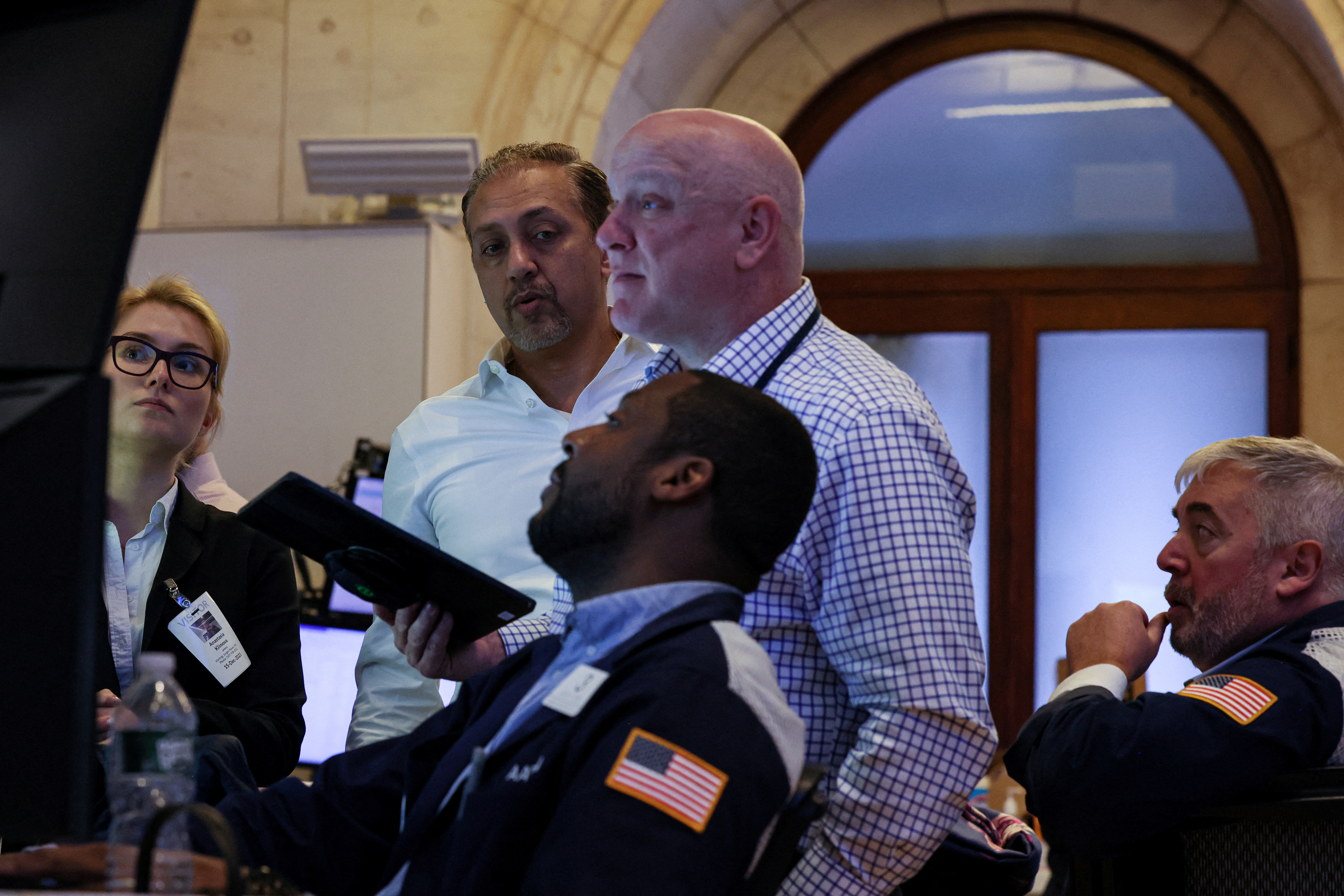 Traders work on the floor at the New York Stock Exchange (NYSE) in New York City, U.S., December 15, 2023. 