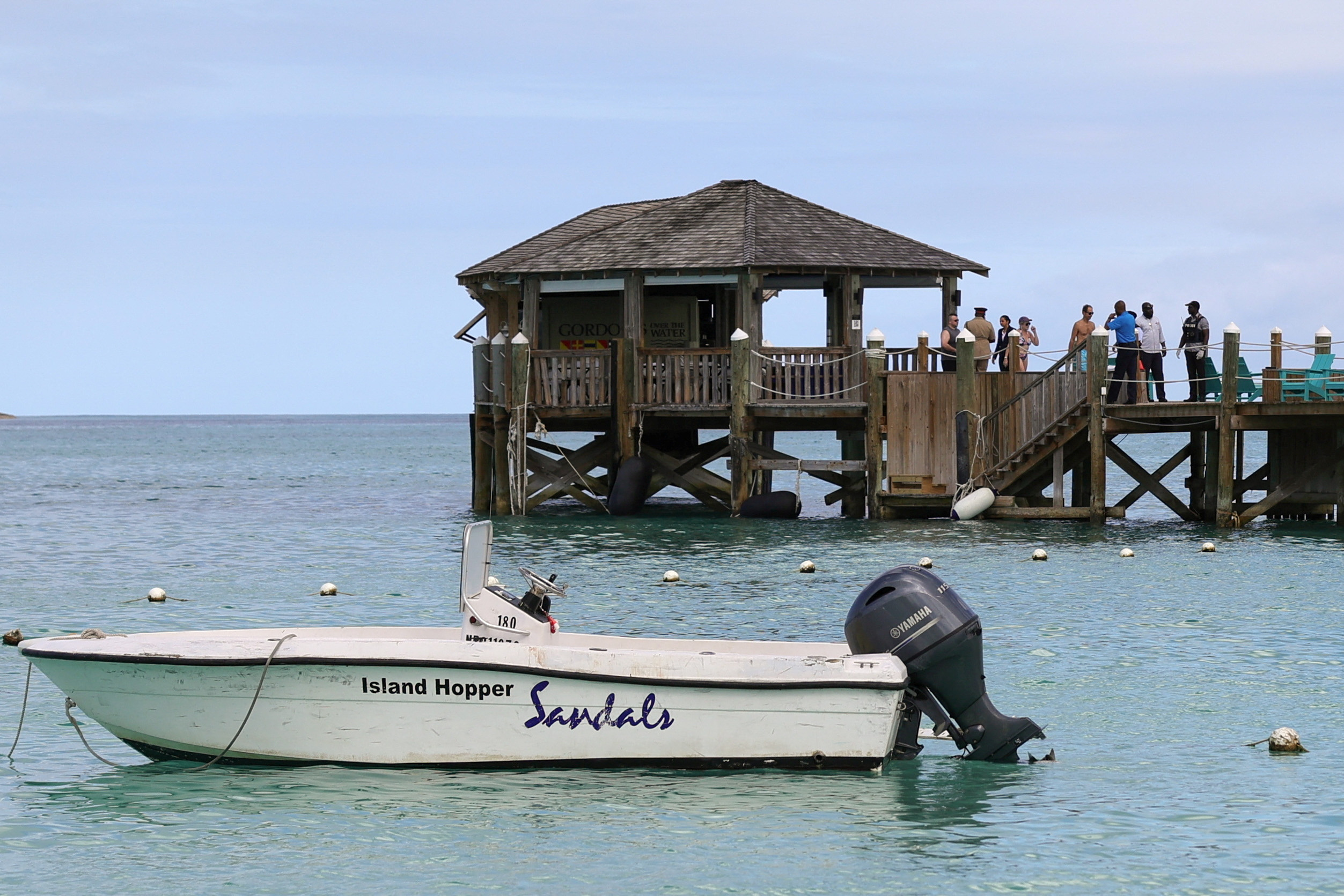 People gather on the resort pier after what police described as a fatal shark attack against a tourist at Sandals Royal Bahamian resort, in Nassau, Bahamas December 4, 2023. 