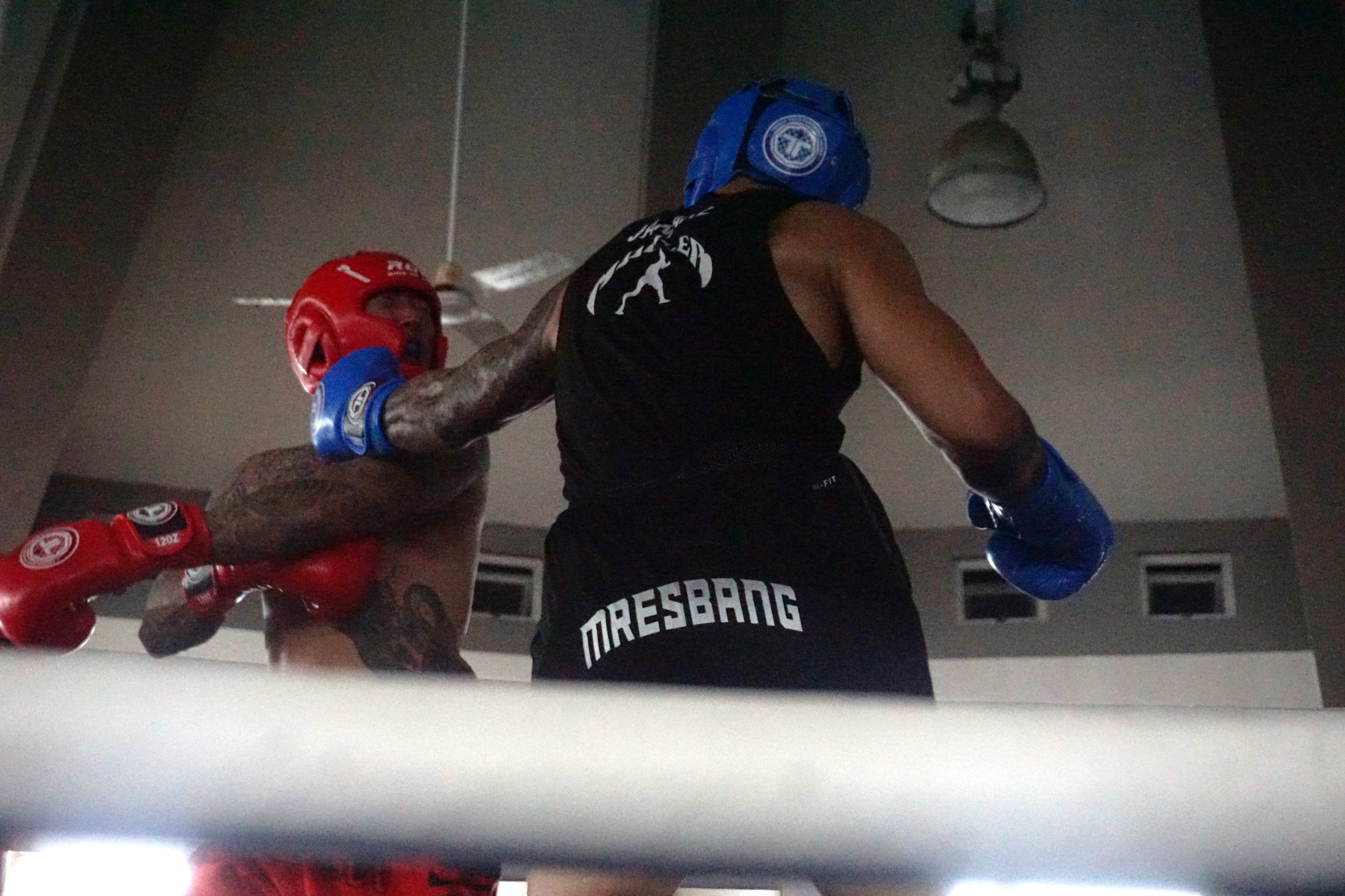 Jamaal Mresbang’s left hook  crashes into Ram Lee's jaw during their Ring of Fire boxing match on Saturday at the Garapan Central Park roundhouse.