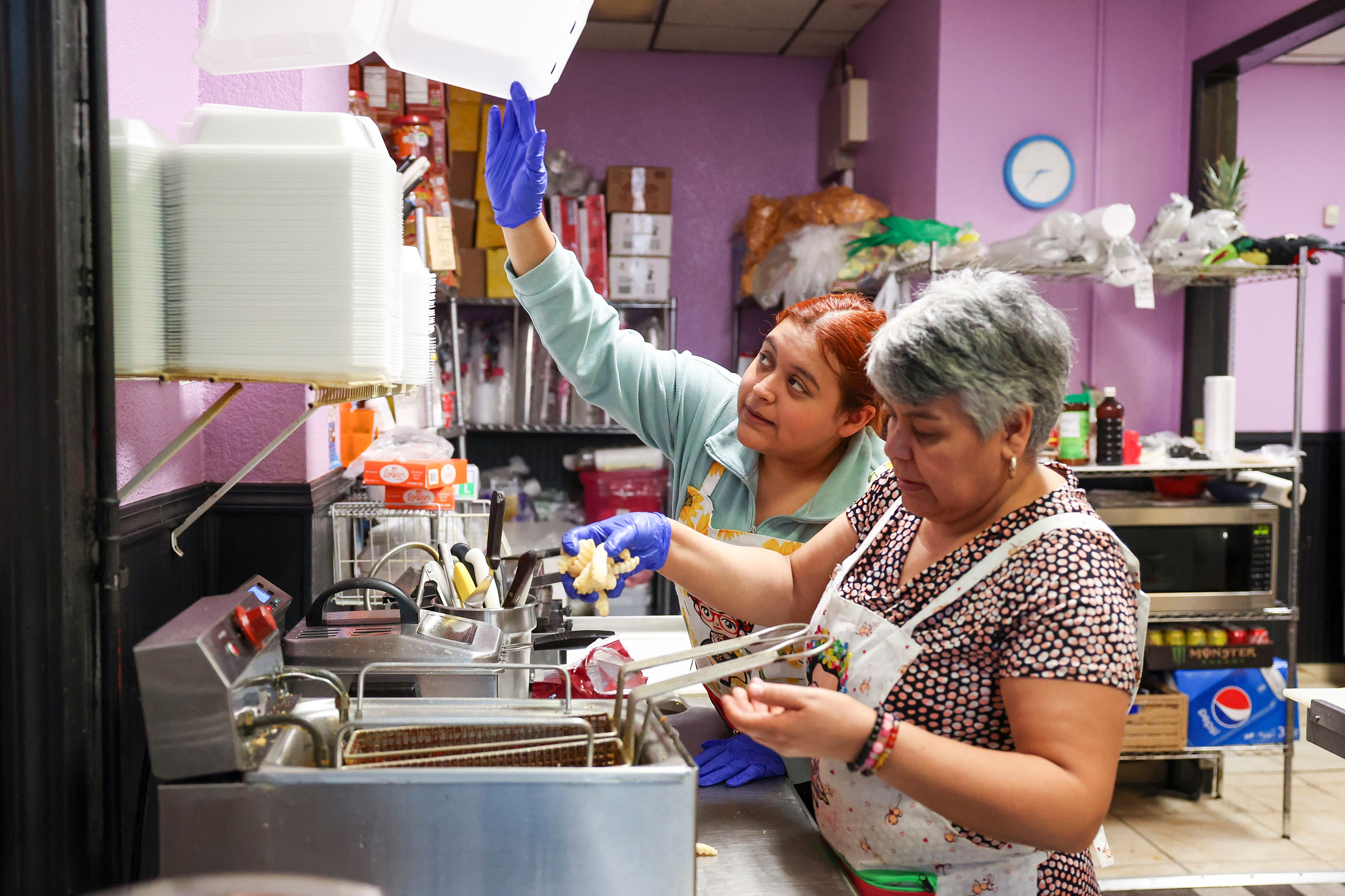 Johanna Rangel and her mother, Juana Arreguin, prepare food at their family's shop, NeverÃ­a El Sabor de MÃ©xico, in Chicago's Pilsen neighborhood on Oct. 12, 2023. (Eileen T. Meslar/Chicago Tribune/TNS)