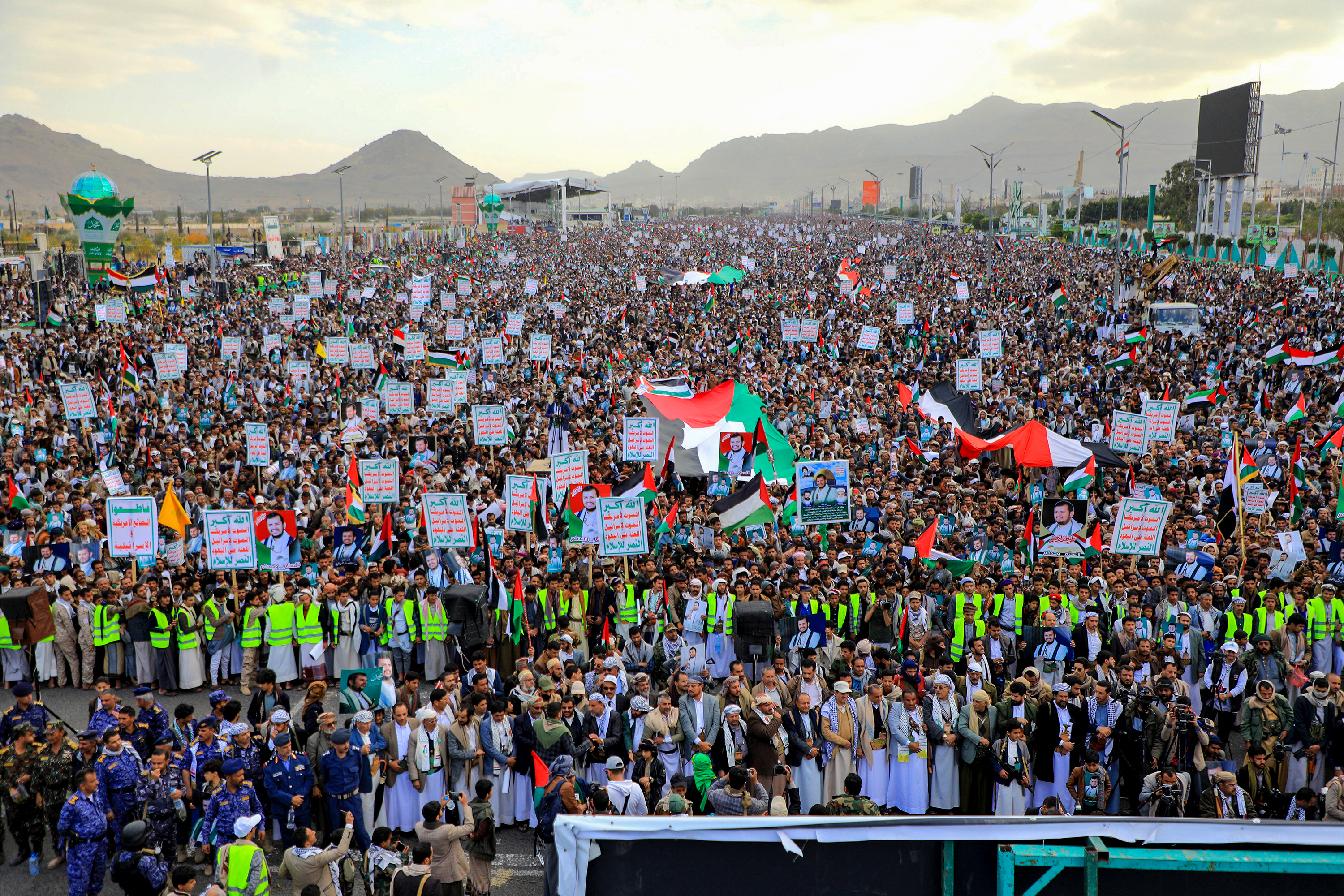 Yemenis chant slogans and wave Palestinian flags during a march in solidarity with the people of Gaza, in the Huthi-controlled capital Sanaa on Dec. 15, 2023. Yemen's Huthi rebels struck a cargo ship in the Red Sea on Dec. 15, causing a fire on deck in the latest of a near-daily series of attacks in the commercially vital waterway. (Mohammed Huwais/AFP/Getty Images/TNS)