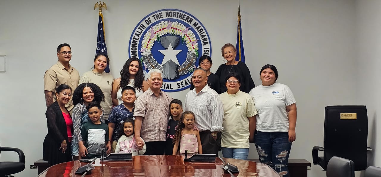 The newly sworn in CNMI Cannabis Commission member, Joe Palacios, poses for a photo with his sisters Becky Cruz and Lucy Palacios, as well as his children, grandchildren and Gov. Arnold I. Palacios on Thursday.