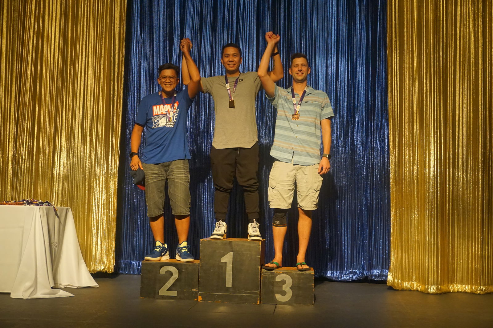 Jomer Enriquez, center, Roy Hernandez, left, and Justin Miller pose for a photo during the awards ceremony of the 2023 Hell of the Marianas on Saturday at the Hyatt Regency Ballroom. The three were the top finishers in the 30-39 age group of the non-pro category.