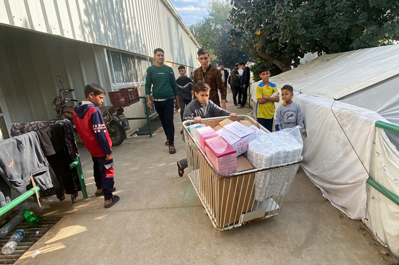 Yazan Fasfous, 13, volunteers to help distribute medical supplies at the European Gaza Hospital, where his mother works, amid the ongoing conflict between Israel and the Palestinian Islamist group Hamas, in Khan Younis, Gaza Strip, December 8, 2023. 