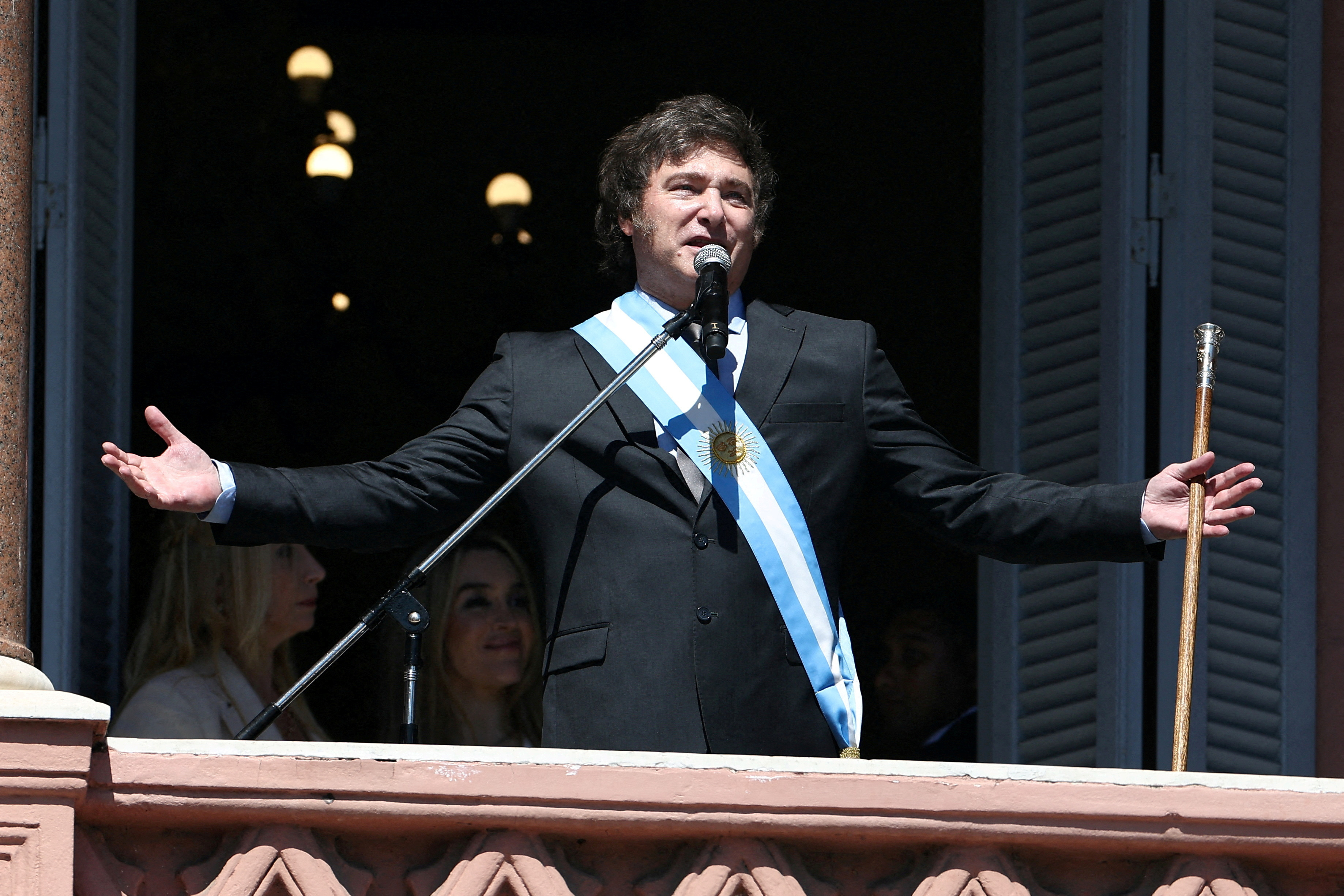 Argentina's President Javier Milei addresses supporters from the Casa Rosada balcony, as his sister Karina Milei and his partner Fatima Florez look on, after his swearing-in ceremony, in Buenos Aires, Argentina December 10, 2023. 