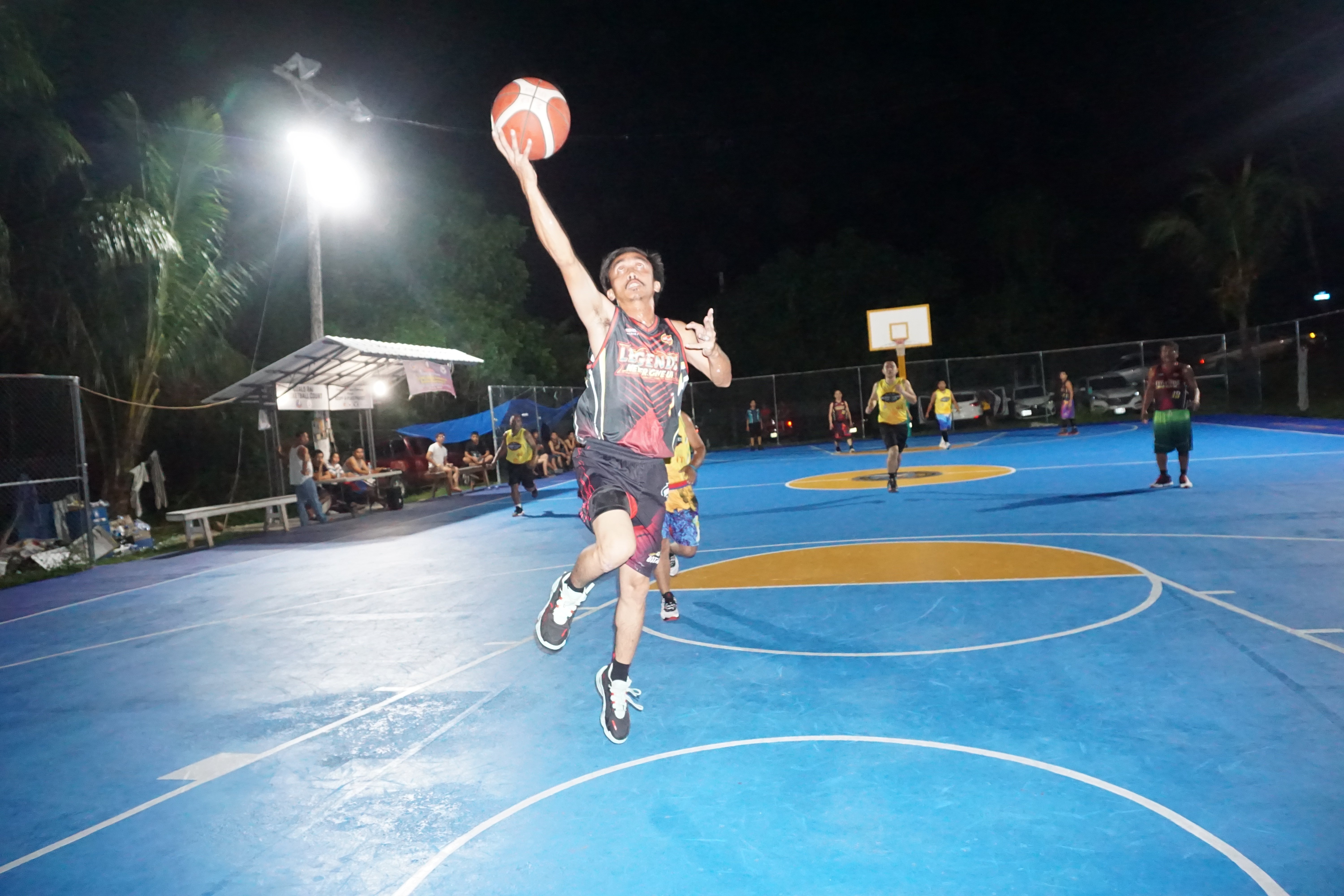 Team Legends' Alken Ege extends for the uncontested finish during a game of the 2023 Pacific Saipan Promo Invitational Basketball League at the Gualo Rai basketball court.