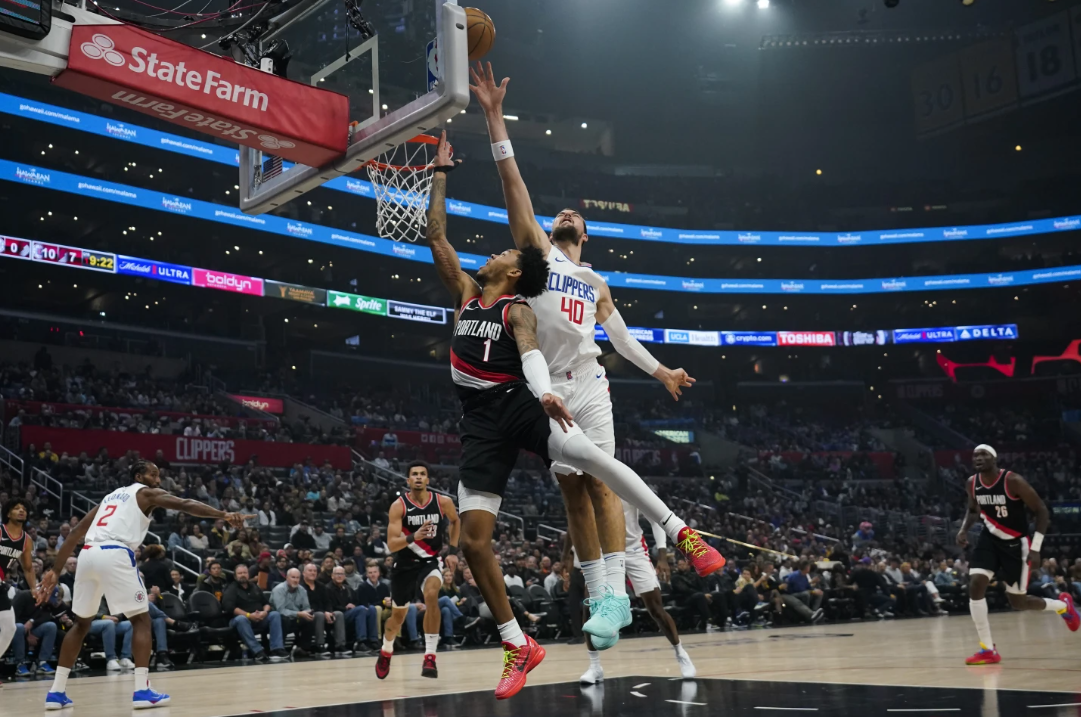 LA Clippers center Ivica Zubac blocks a shot by Portland Trail Blazers guard Anfernee Simons (1) during the first half of an NBA game in Los Angeles, Monday, Dec. 11, 2023.