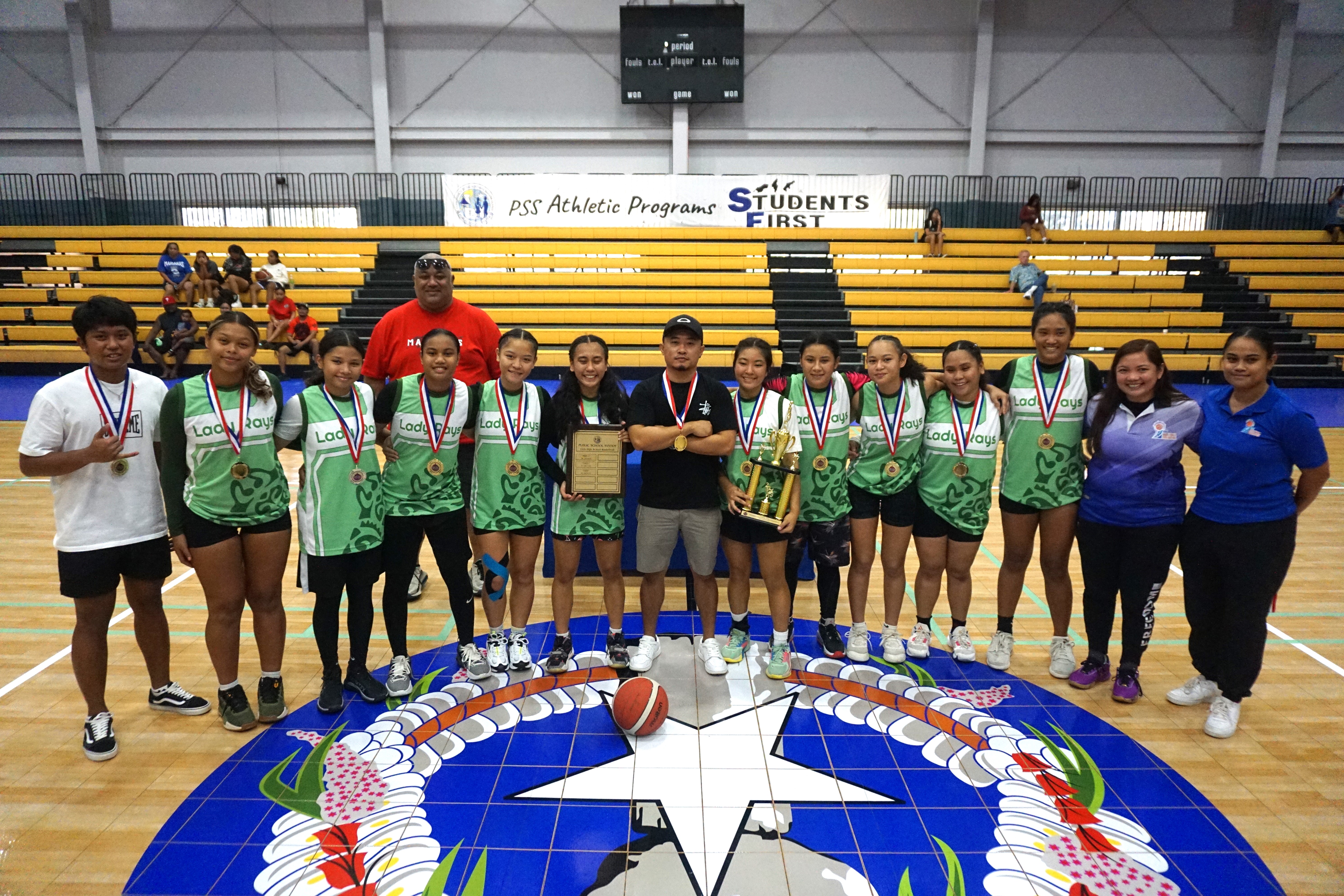 Saipan Southern High School team members pose for a photo with the championship trophy along with PSS interscholastic  and NMI Basketball Federation officers during the awards ceremony of the IT&E Interscholastic Basketball League SY 23-24 at the Ada gym on Saturday.