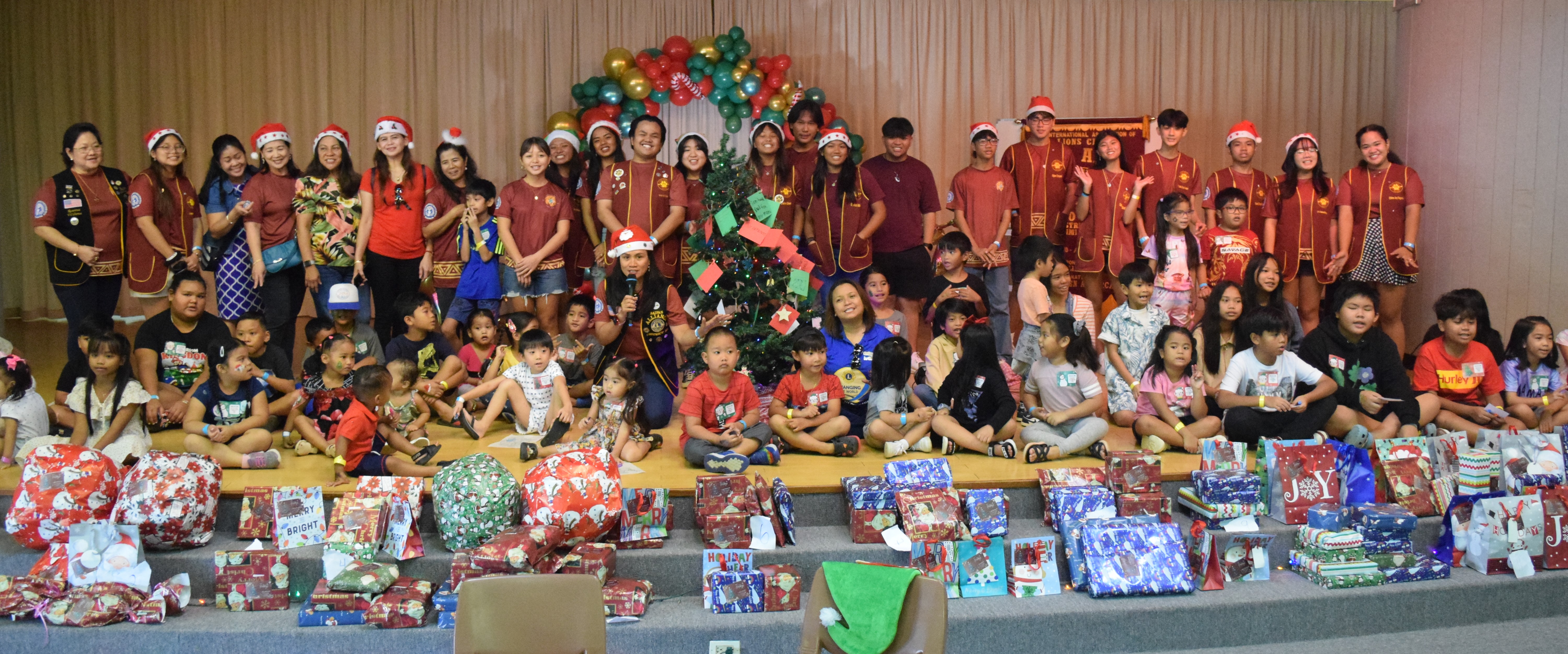 The Saipan Cubs Alpha Leo Club officers and members pose with children who received gifts from the organization at the Gov. Pedro P. Tenorio Multi-Purpose Center on Saturday.