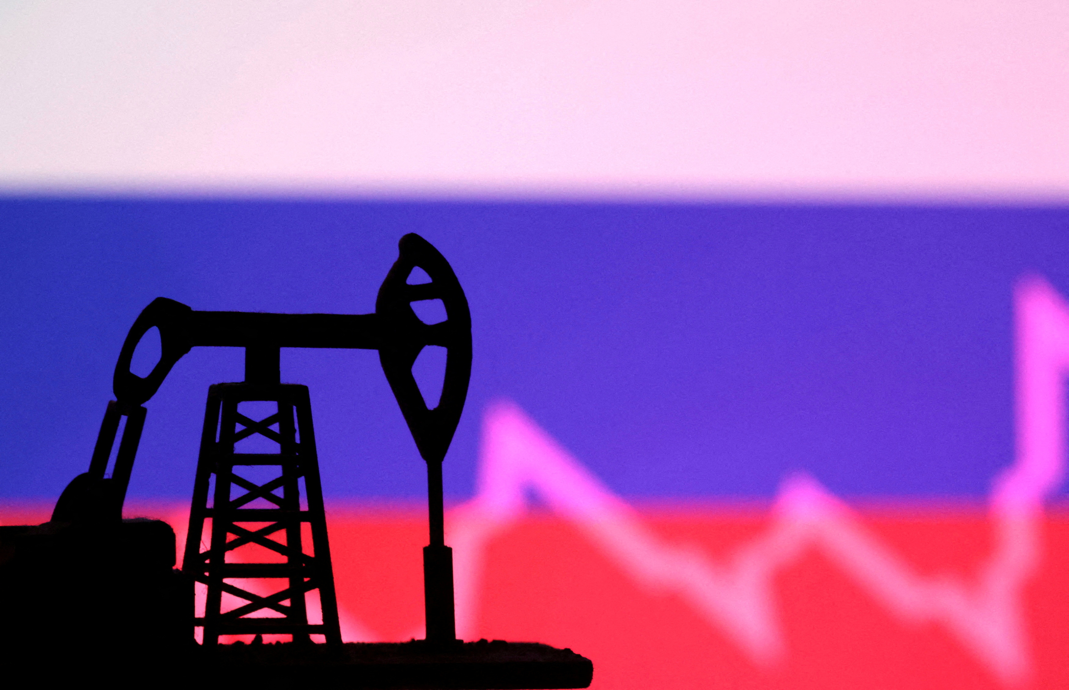 Russian flag with stock graph and an oil pump jack miniature model are seen in this illustration taken October 9, 2023. 