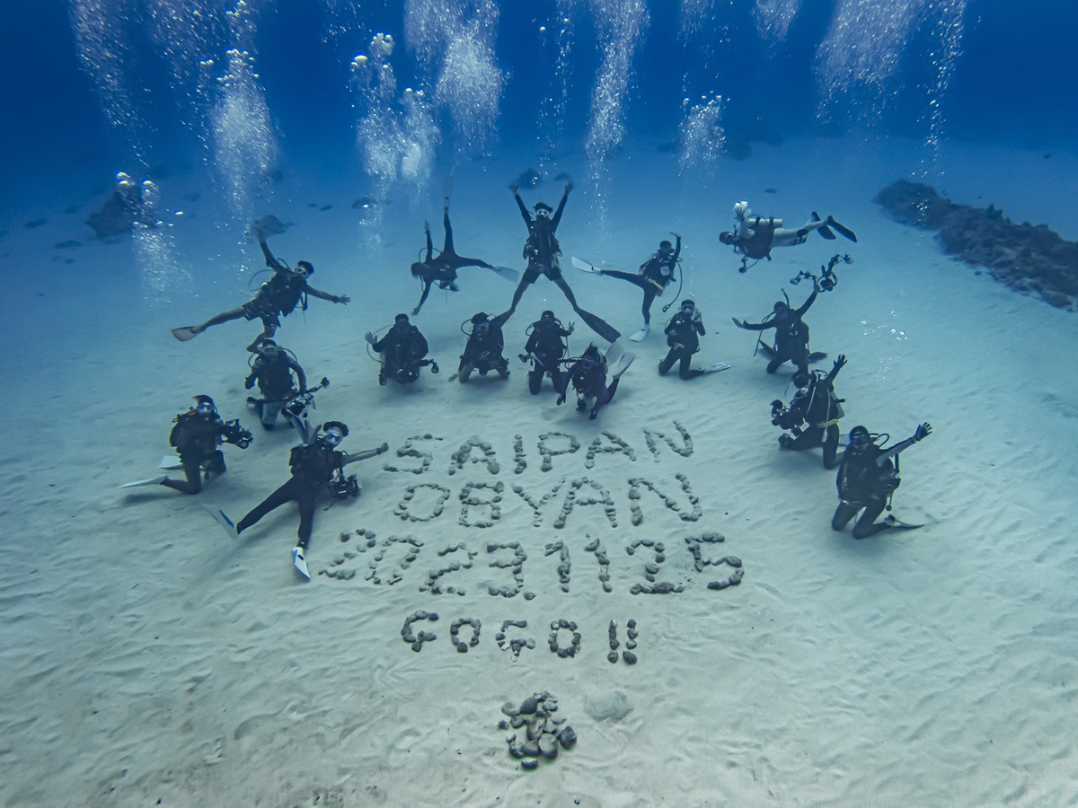 Participants in the Marianas Diving Promotion underwater photography seminar take a commemorative photo at Obyan Beach in Saipan on Nov. 25, 2023.