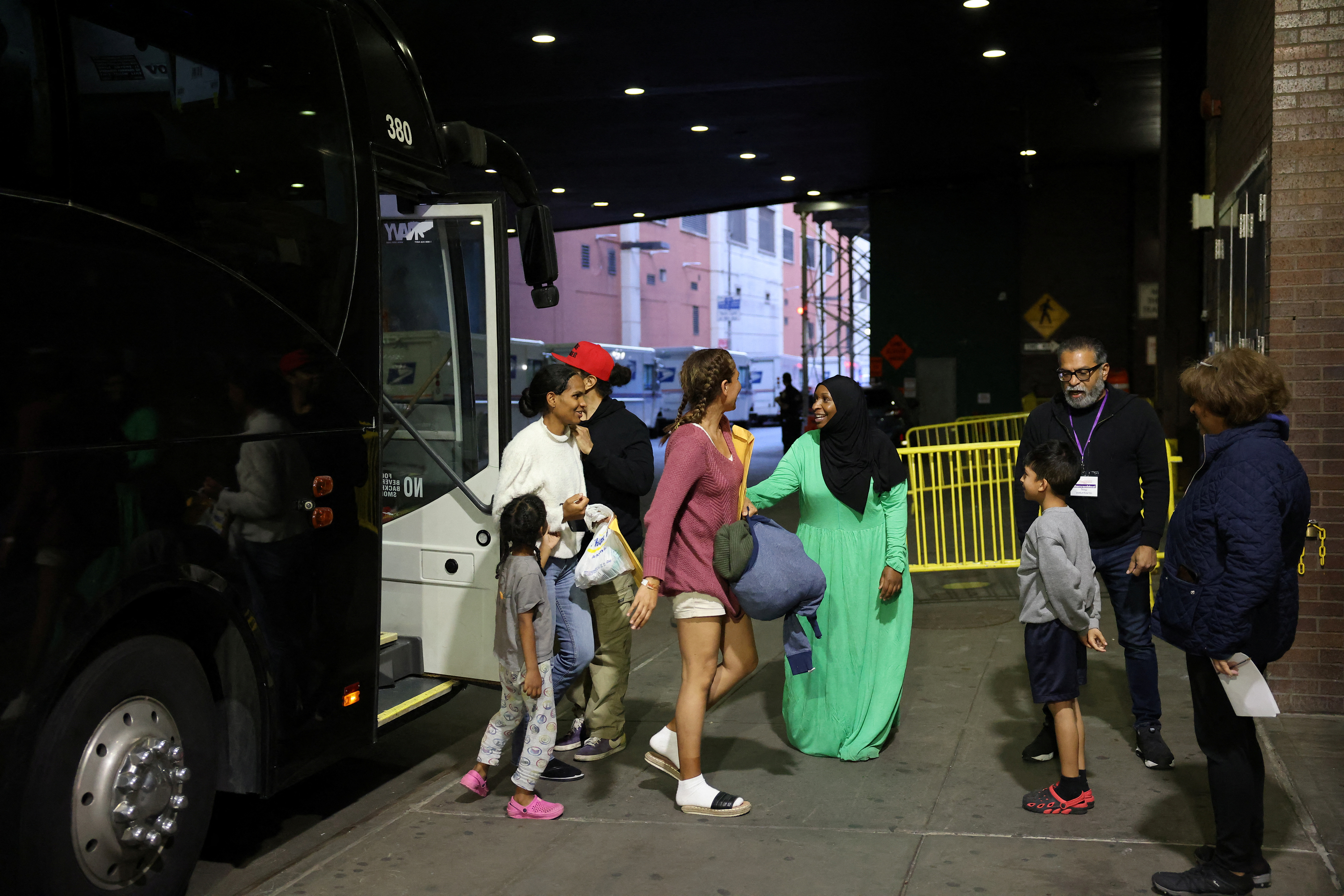 Migrants arriving from Texas by bus disembark at the Port Authority bus terminal in New York City, U.S., May 10, 2023. 