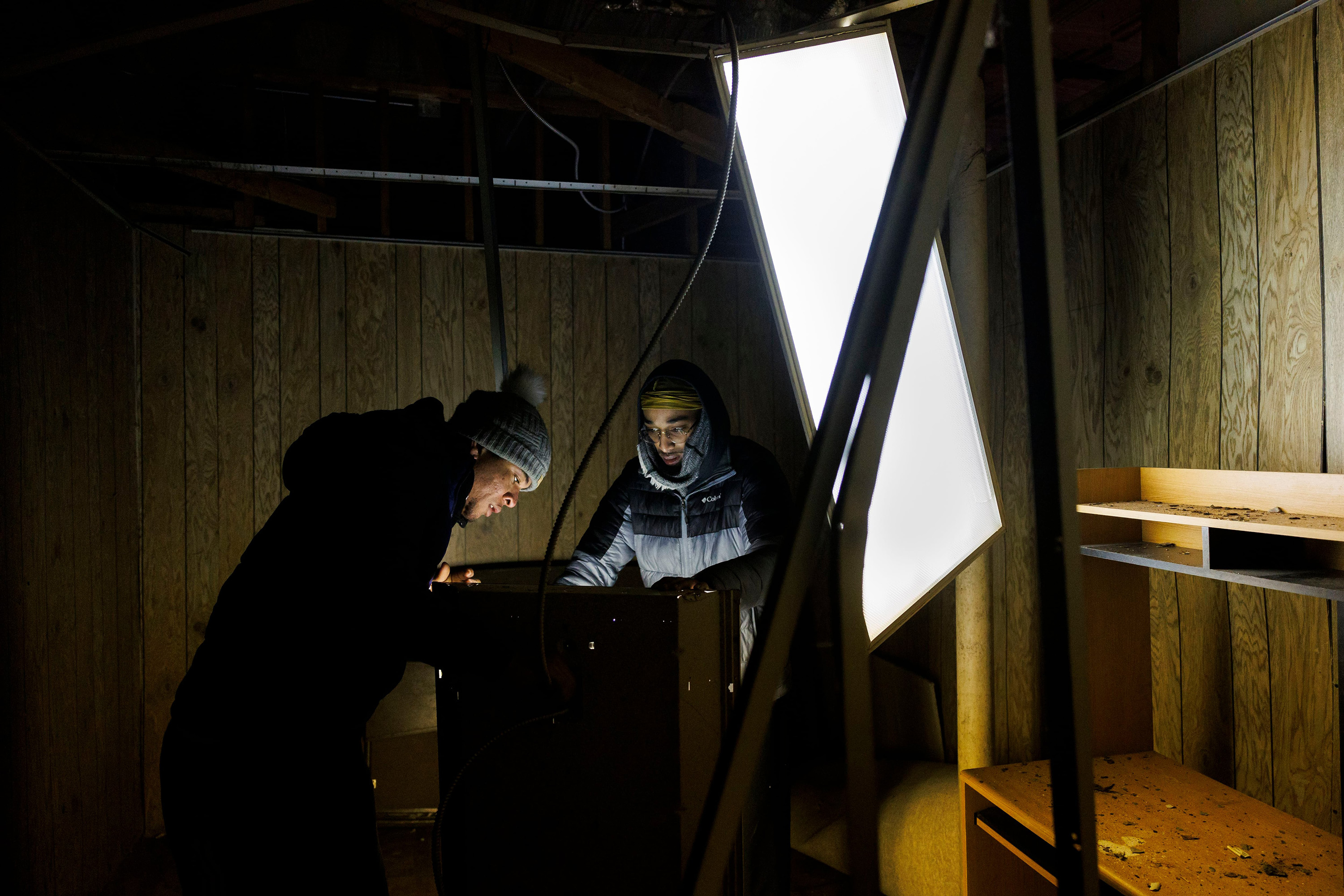 Rayni Cuadrado, left, of Venezuela, and pastor Markel Anderson remove broken light panels on Jan. 11, 2024, from a room at New Promise Land Missionary Baptist Church in Chicago's North Lawndale neighborhood after it was broken into. (Armando L. Sanchez/Chicago Tribune/TNS)