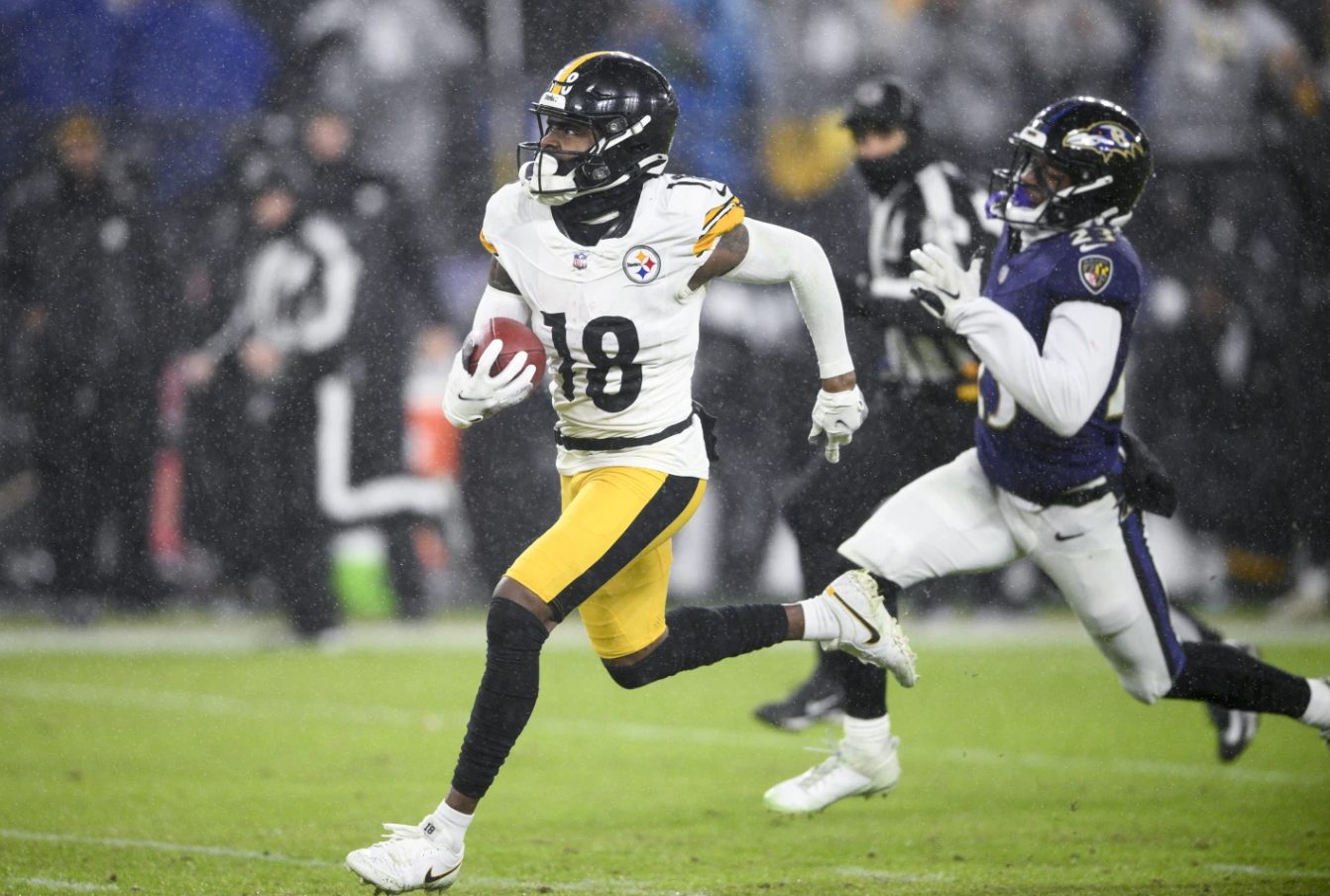 Pittsburgh Steelers wide receiver Diontae Johnson (18) runs for a long touchdown after making a catch in front of Baltimore Ravens cornerback Rock Ya-Sin (23) during the second half of an NFL game, Saturday, Jan. 6, 2024.