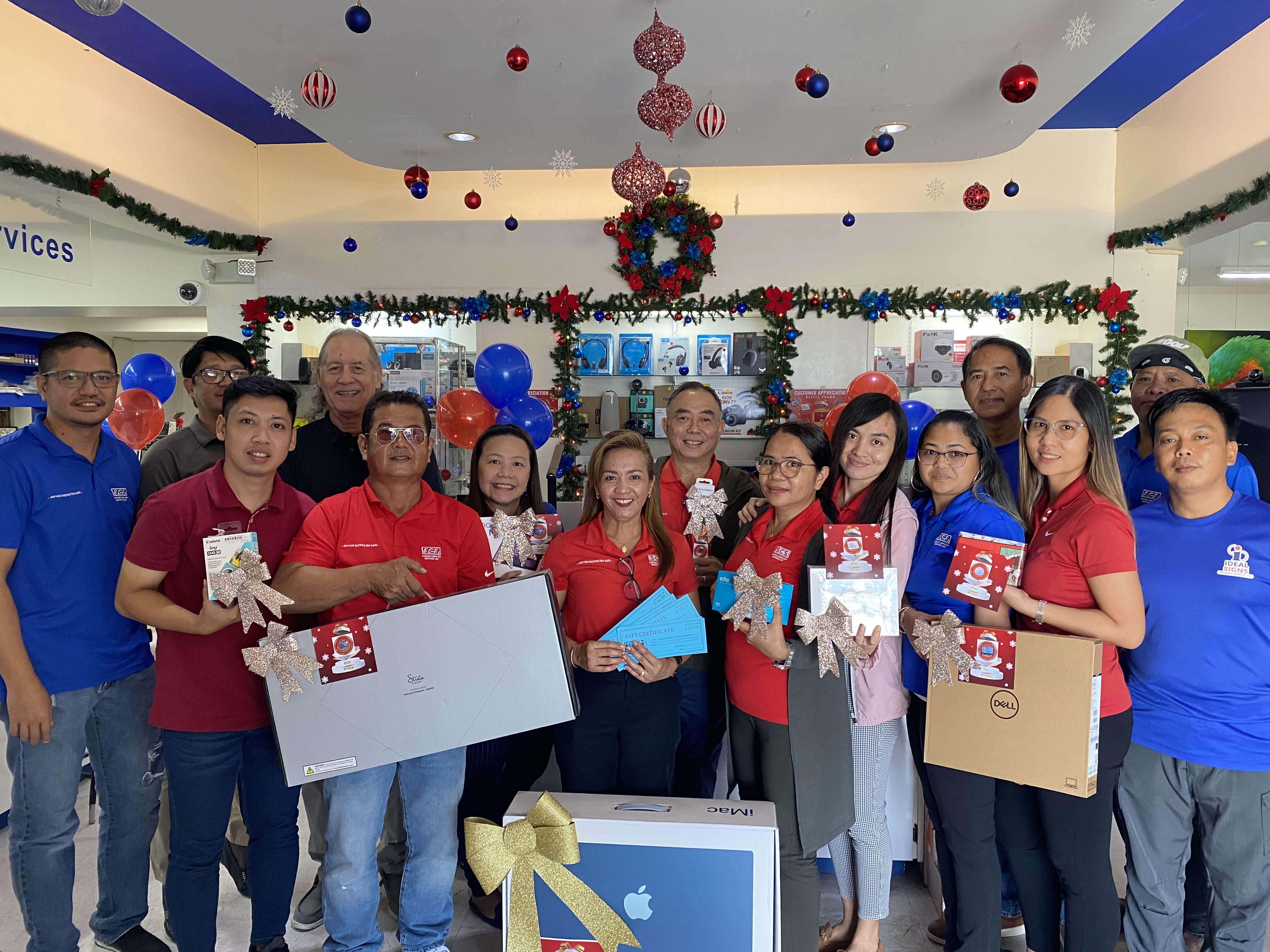The staff members of Saipan Computer Store pose with the prizes they raffled off on Dec. 29, 2023, at their Garapan store.