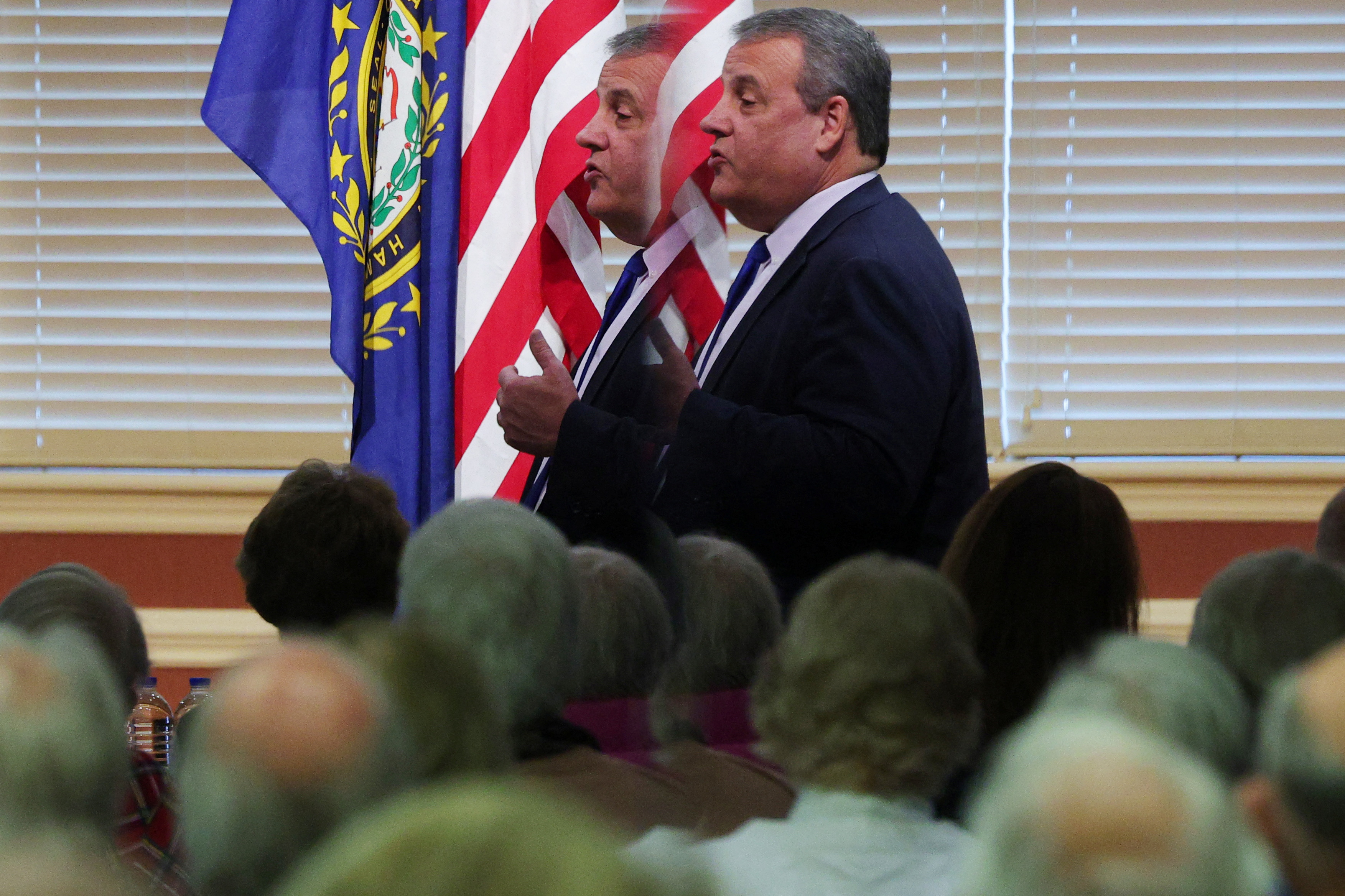 An audience member records as Republican presidential candidate and former New Jersey Governor Chris Christie is reflected in a mirror while speaking at a campaign stop at the RiverWoods Retirement Community in Exeter, New Hampshire, U.S., January 10, 2024.